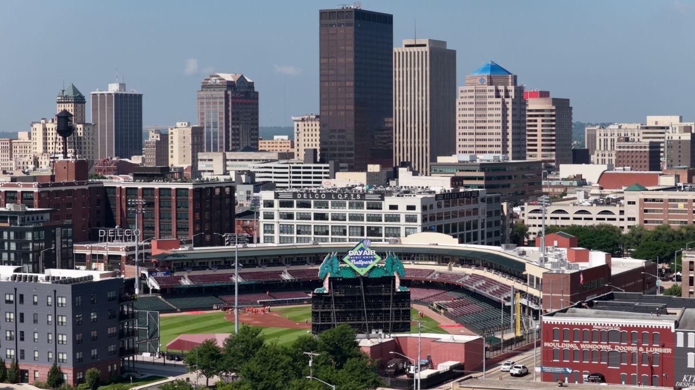 Aerial view of a baseball stadium surrounded by urban buildings in a city.