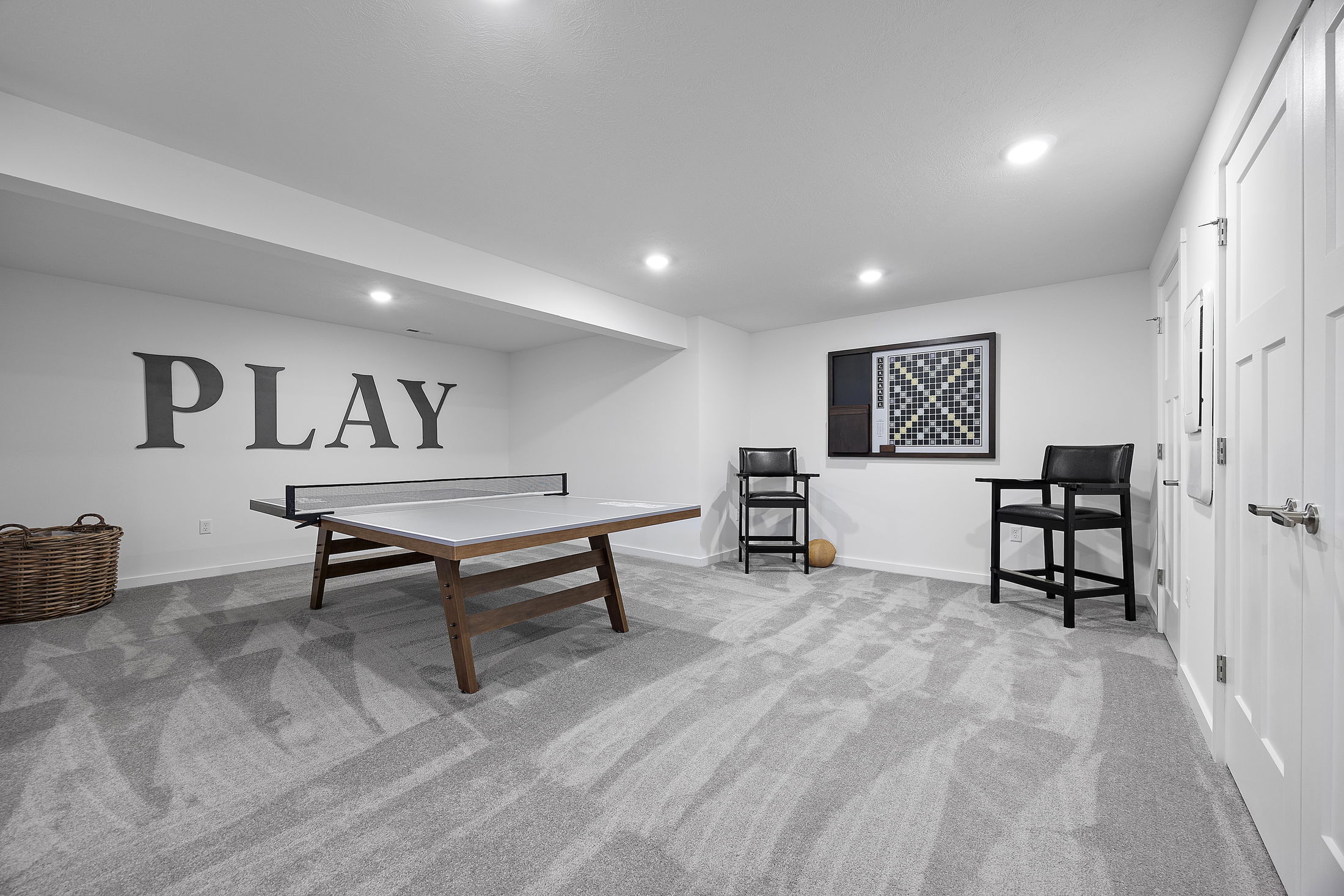 Modern basement game room with a ping pong table, decorative \\\