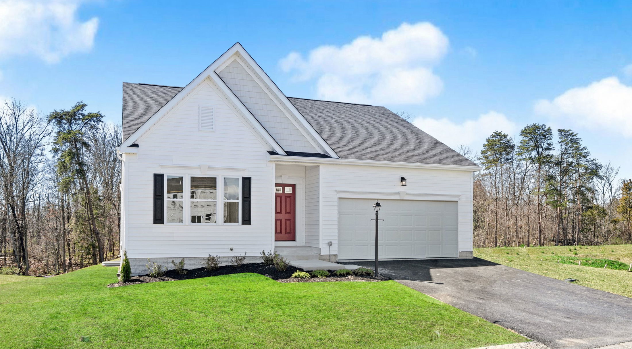 white patio home with a red door in butler county