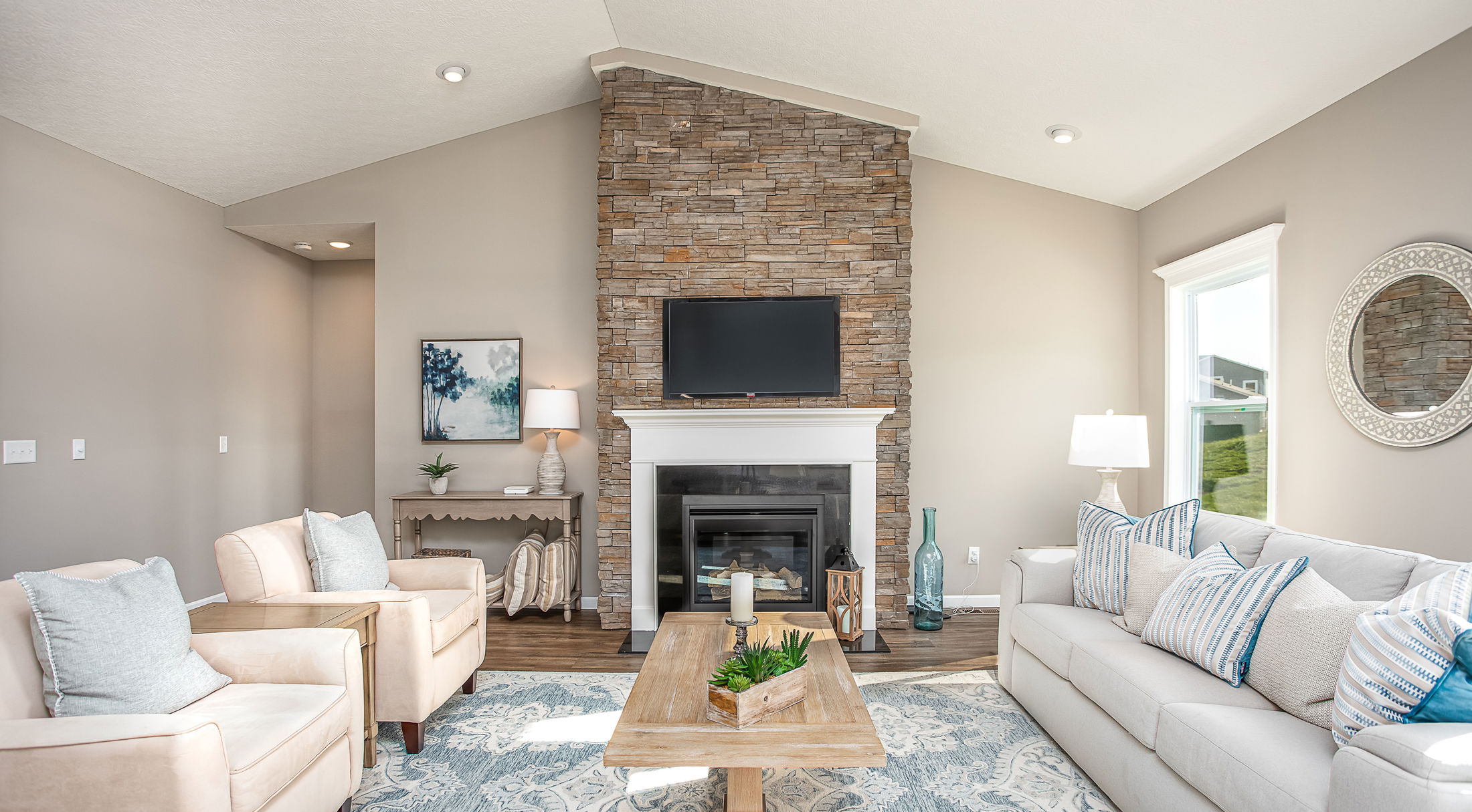 living room with coastal decor and stone fireplace in a new home in butler