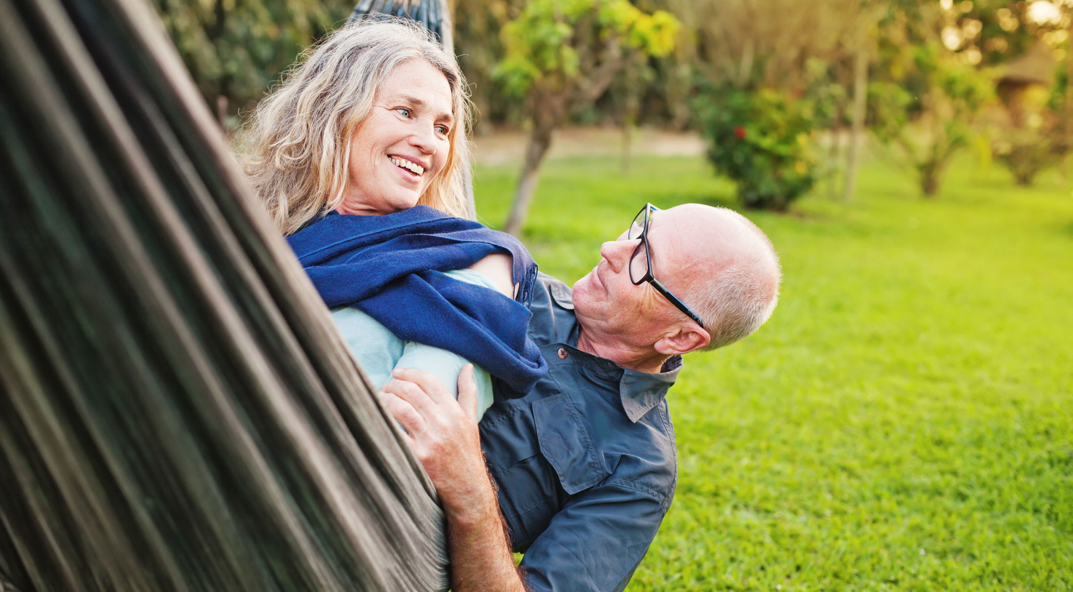 a 55 plus couple relaxing in a hammock