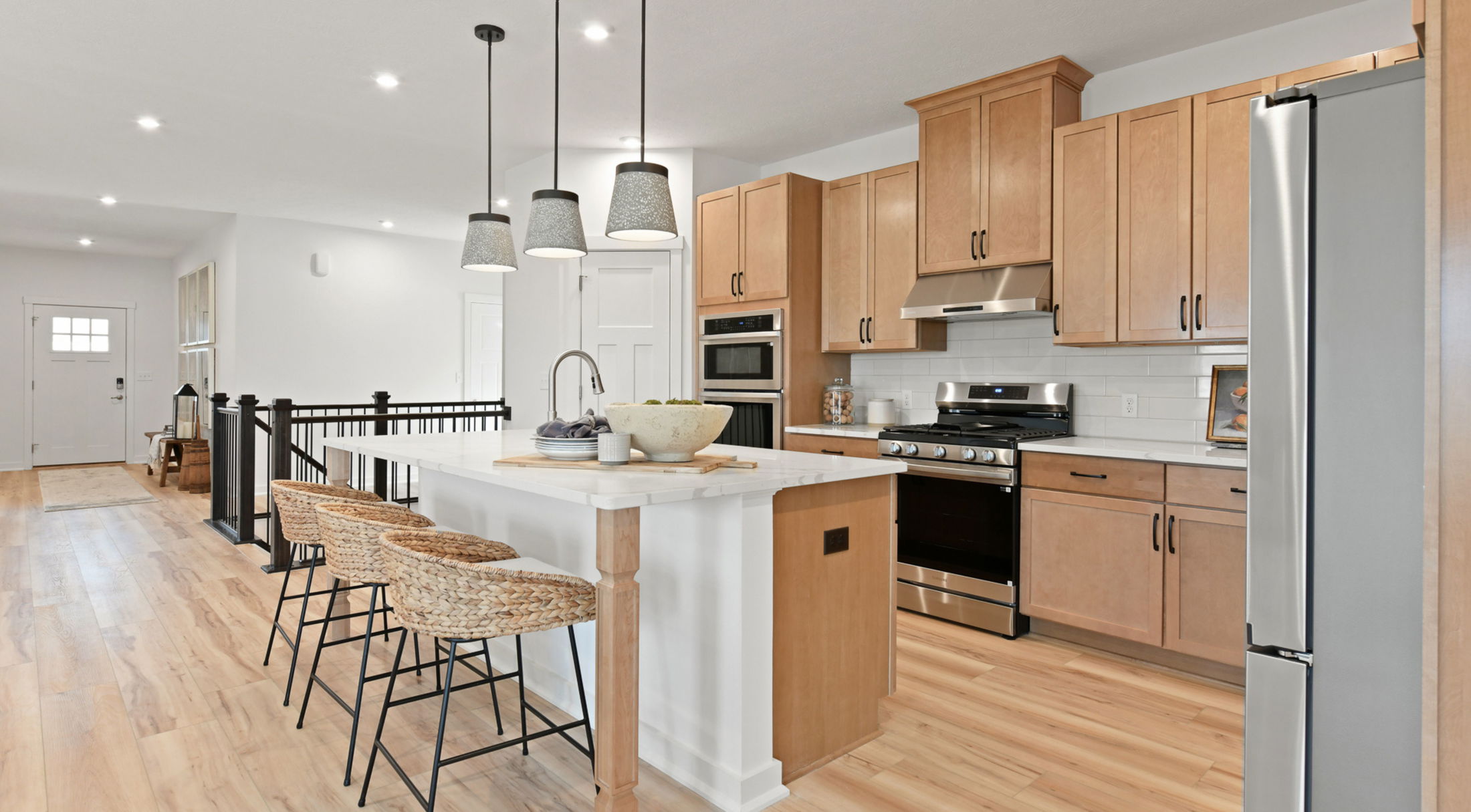 modern kitchen next to black stairs in a new home in butler