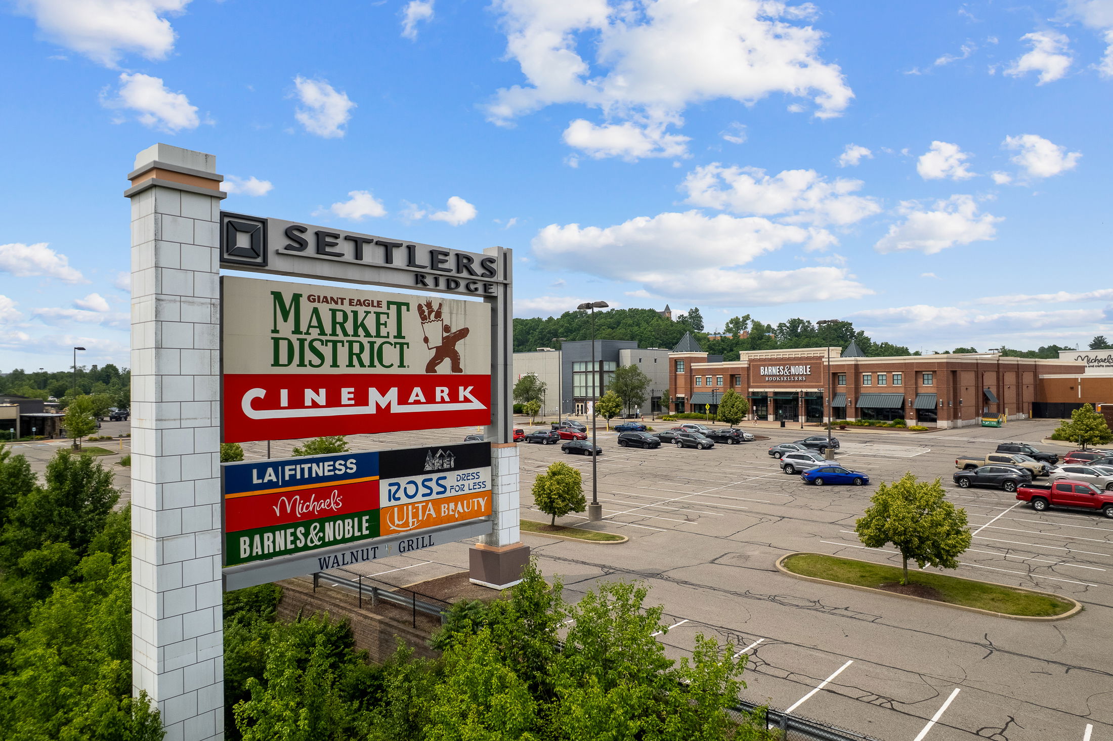 Settlers Ridge shopping center featuring store signs for Giant Eagle Market District, Cinemark, LA Fitness, Michaels, Ross Dress for Less, Ulta Beauty, Barnes & Noble, and Walnut Grill.