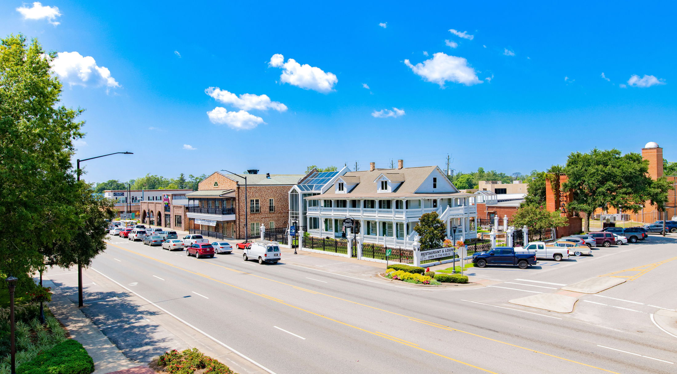 Street view of Augusta, Georgia, showcasing historic buildings and traffic under a clear blue sky.