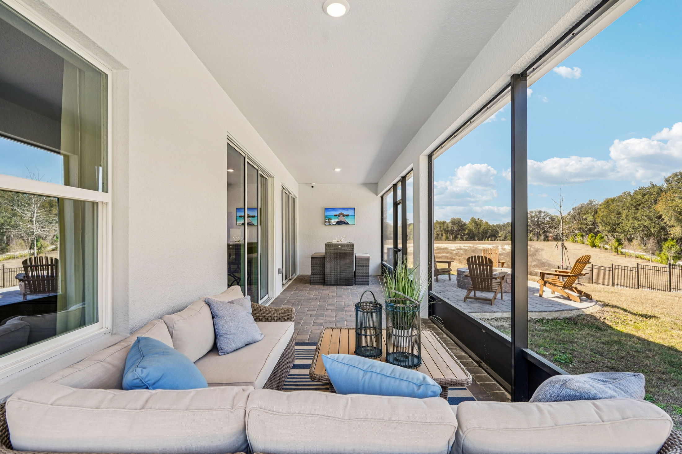 Spacious and modern patio with comfortable seating, outdoor dining area, and scenic views.