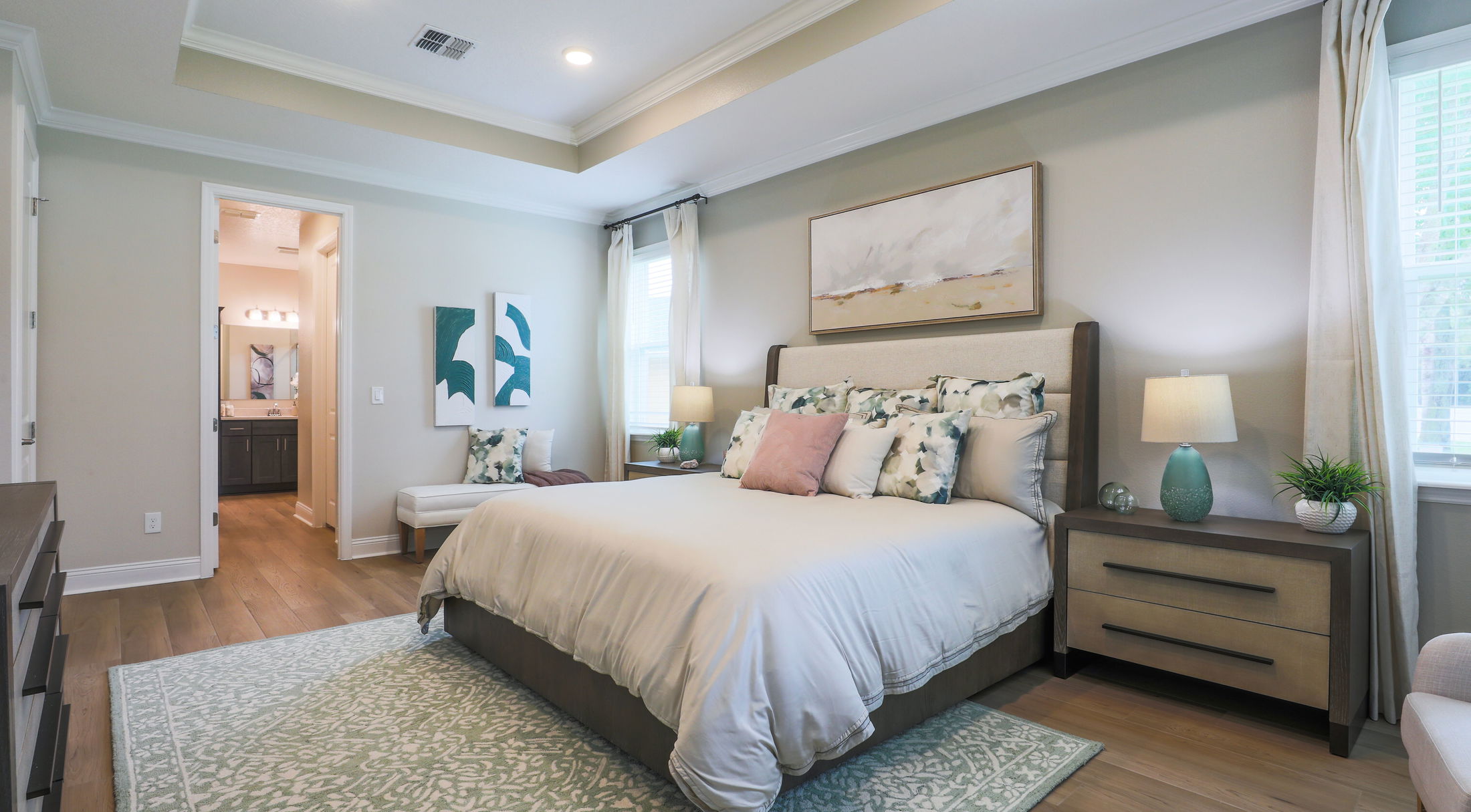 Cozy modern bedroom with stylish decor, featuring a plush bed, patterned rug, and elegant lighting.