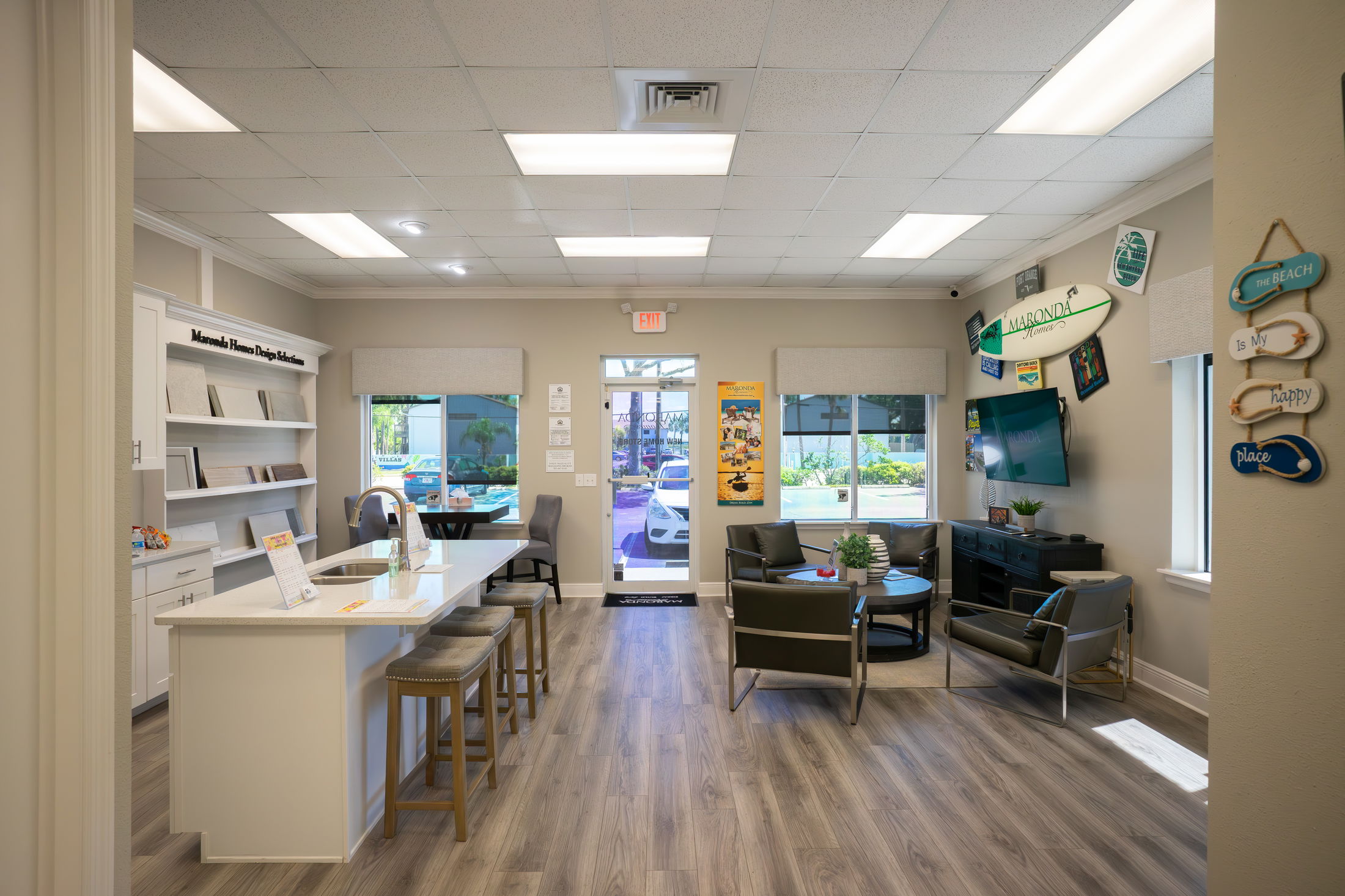 Modern home design studio with sleek countertops, display samples, and comfortable seating area, showcasing interior design elements.