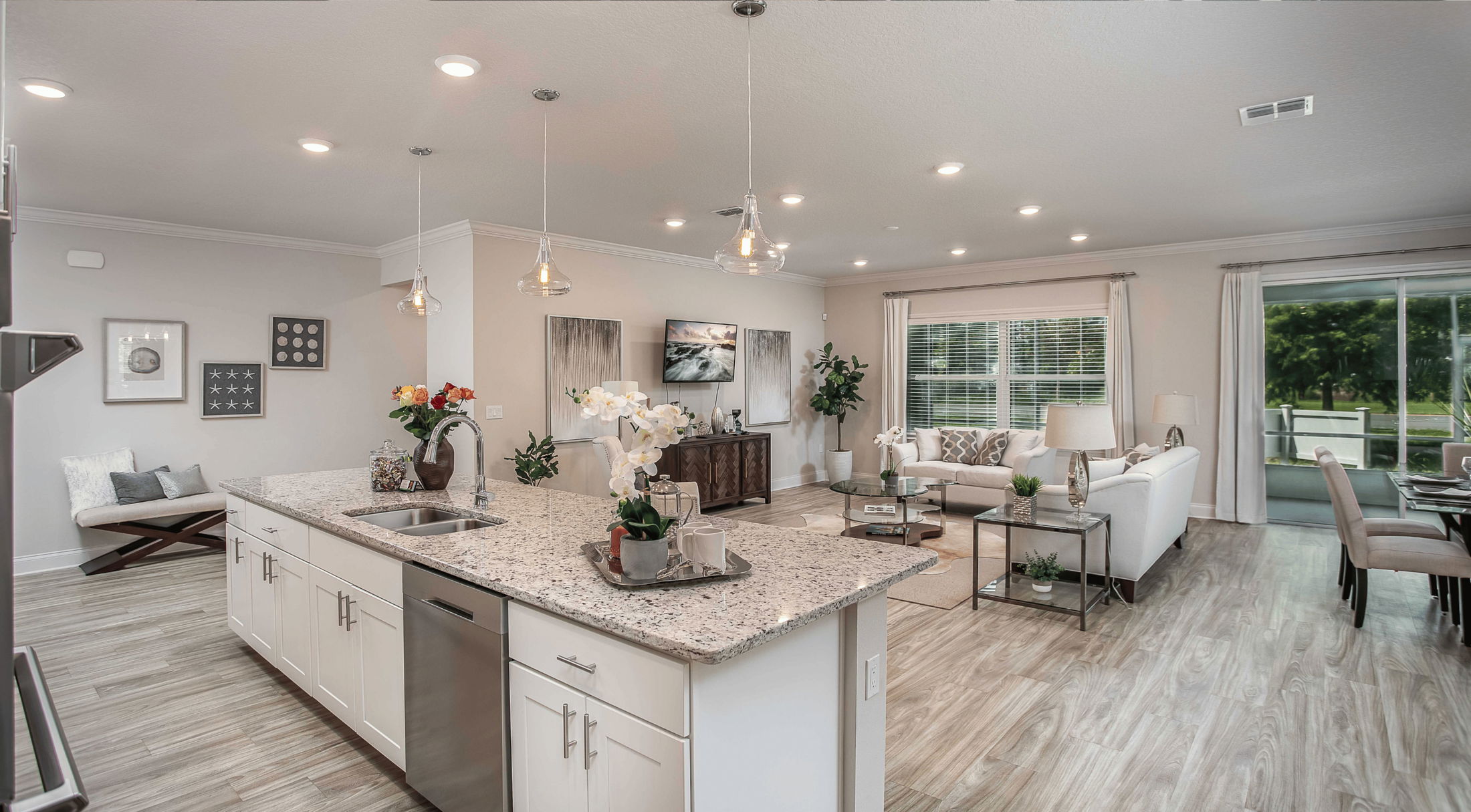 open floor plan white kitchen with view of living room and dining area in a new home in grant-valkaria, fl