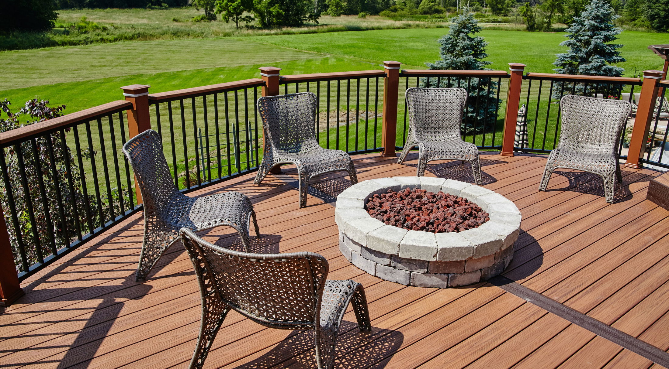 curved deck with a firepit and five chairs in a new home in grant-valkaria, fl