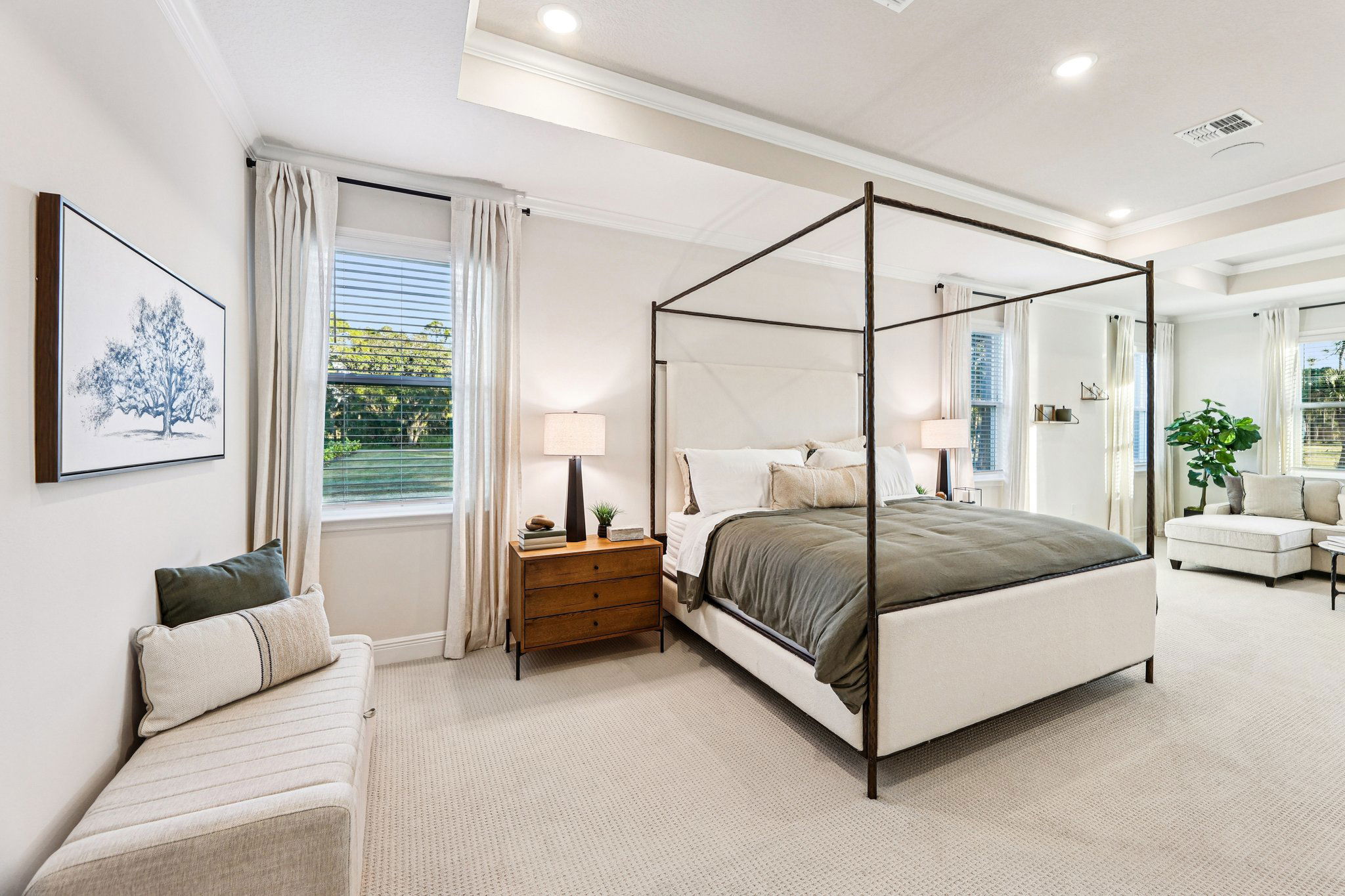 Sophisticated modern bedroom with a canopy bed, neutral decor, and ample natural light.