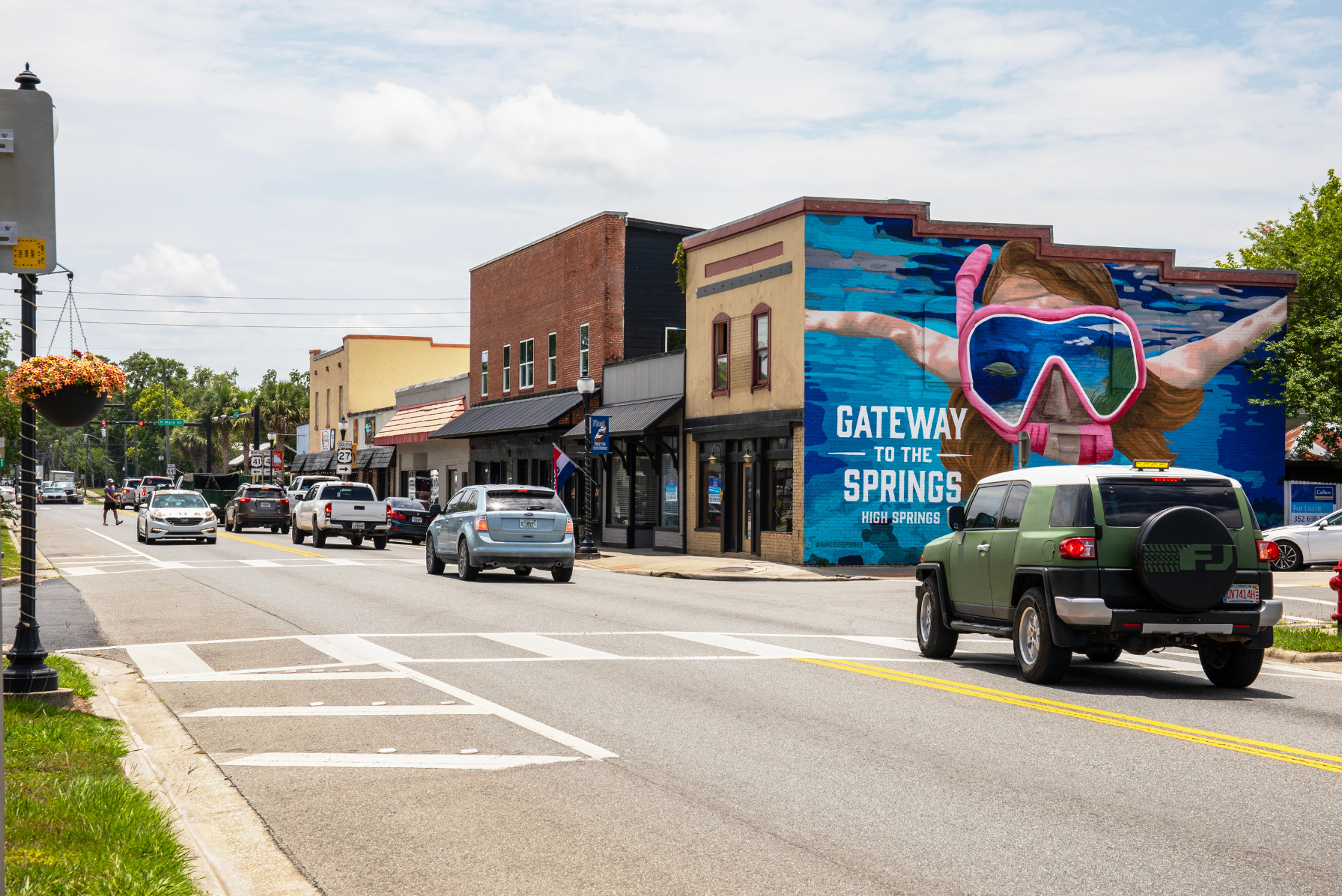 Street view of downtown High Springs, Florida, featuring vibrant mural art with the text \\\\\\\\\\\\\\\\\\\\\\\\\\\\\\\\\\\\\\\\\\\\\\\\\\\\\\\\\\\\\\\\\\\\\\\\\\\\\\\\\\\\\\\\\\\\\\\\\\\\\\\\\\\\\\\\\\\\\\\\\\\\\\\\\\\\\\\\\\\\\\\\\\\\\\\\\\\\\\\\\\\\\\\\\\\\\\\\\\\\\\\\\\\\\\\\\\\\\\\\\\\\\\\\\\\\\\\\\\\\\\\\\\\\\\\\\\\\\\\\\\\\\\\\\\\\\\\\\\\\\\\\\\\\\\\\\\\\\\\\\\\\\\\\\\\\\\\\\\\\\\\\\\\\\\\\\\\\\\\\\\\\\\\\\\\\\\\\\\\\\\\\\\\\\\\\\\\\\\\\\\\\\\\\\\\\\\\\\\\\\\\\\\\\\\\\\\\\\\\\\\\\\\\\\\\\\\\\\\\\\\\\\\\\\\\\\\\\\\\\\\\\\\\\\\\\\\\\\\\\\\\\\\\\\\\\\\\\\\\\\\\\\\\\\\\\\\\\\\\\\\\\\\\\\\\