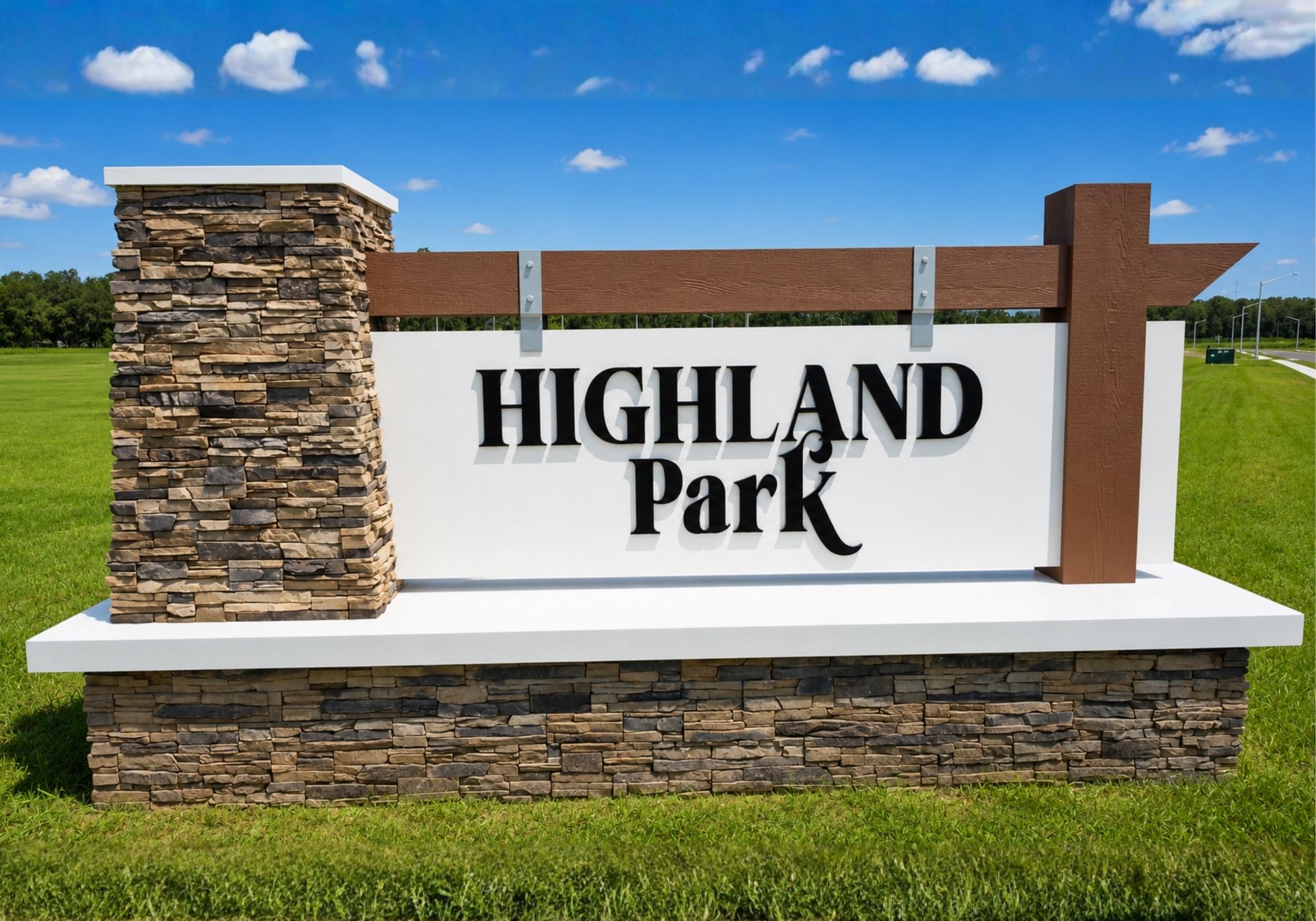 Sign for Highland Park with a stone base and wooden accents against a blue sky.