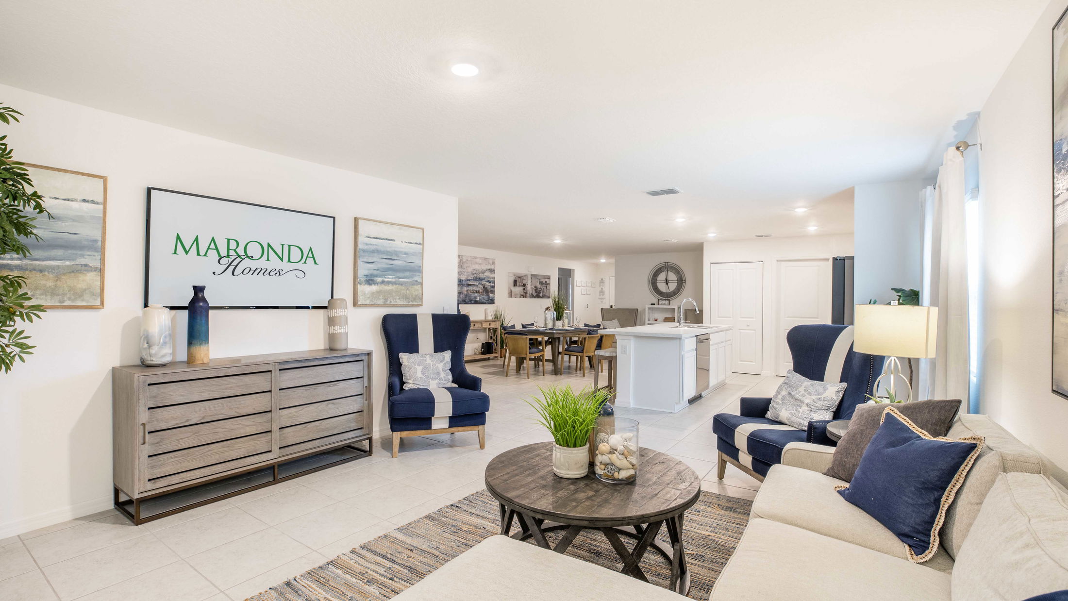 Elegant modern living room interior with blue and beige accents, featuring a wall-mounted TV displaying \\\\\\\\\\\\\\\