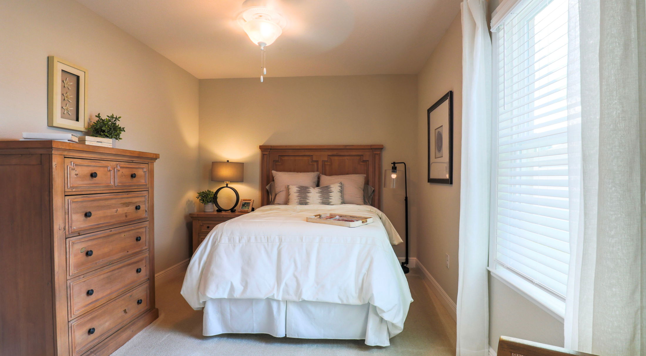 Cozy and stylish bedroom with wooden furniture, white bedding, and soft lighting.
