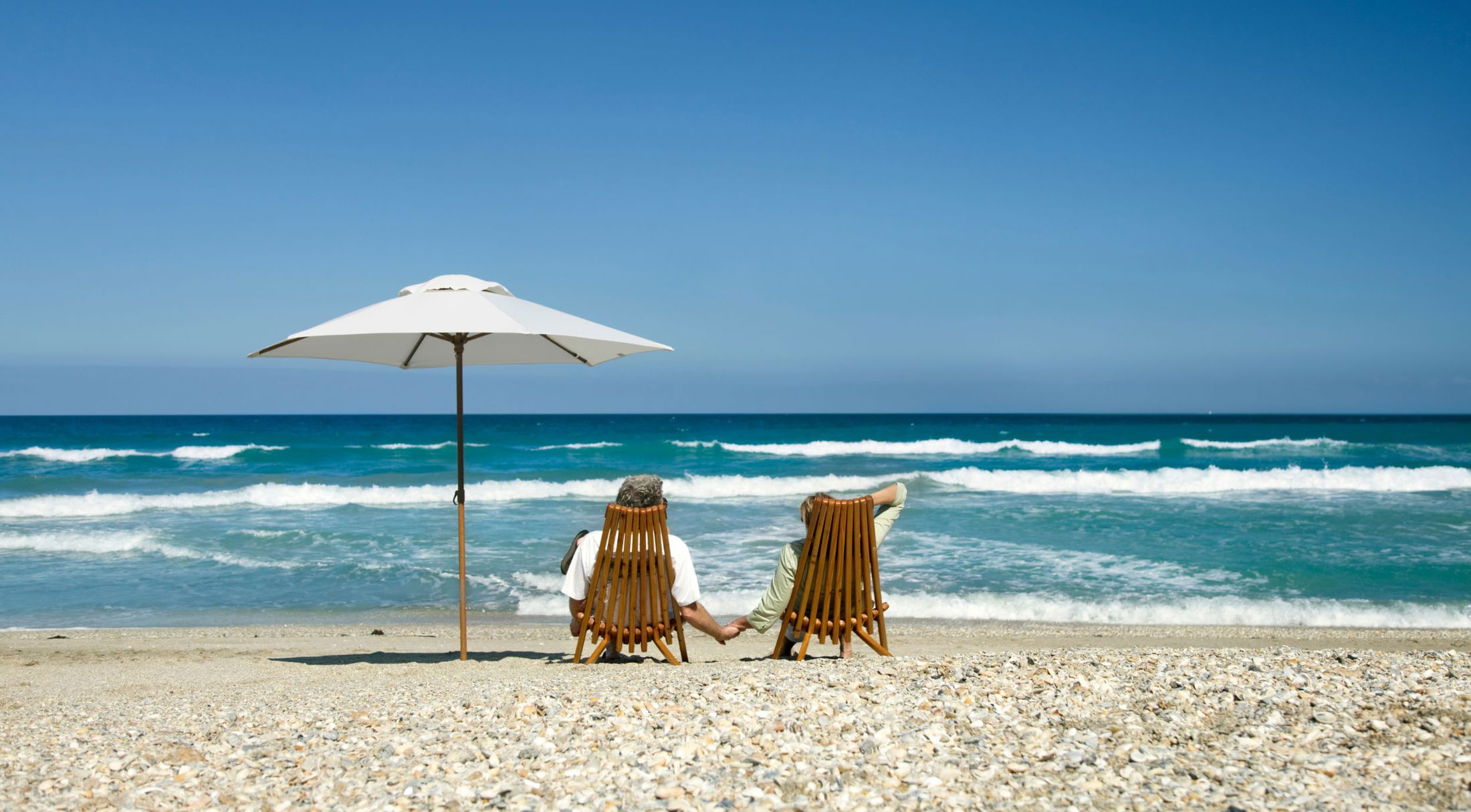 a couple sitting in lounge chairs on the beach near naples, fl