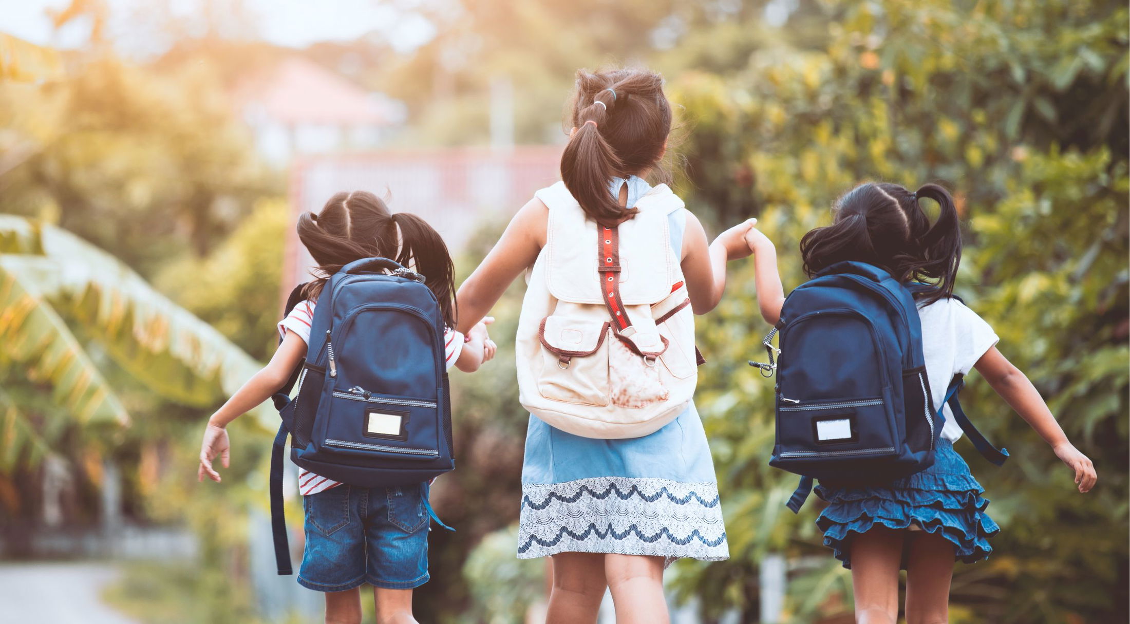 three children walking hand in hand on their way to school in naples, fl