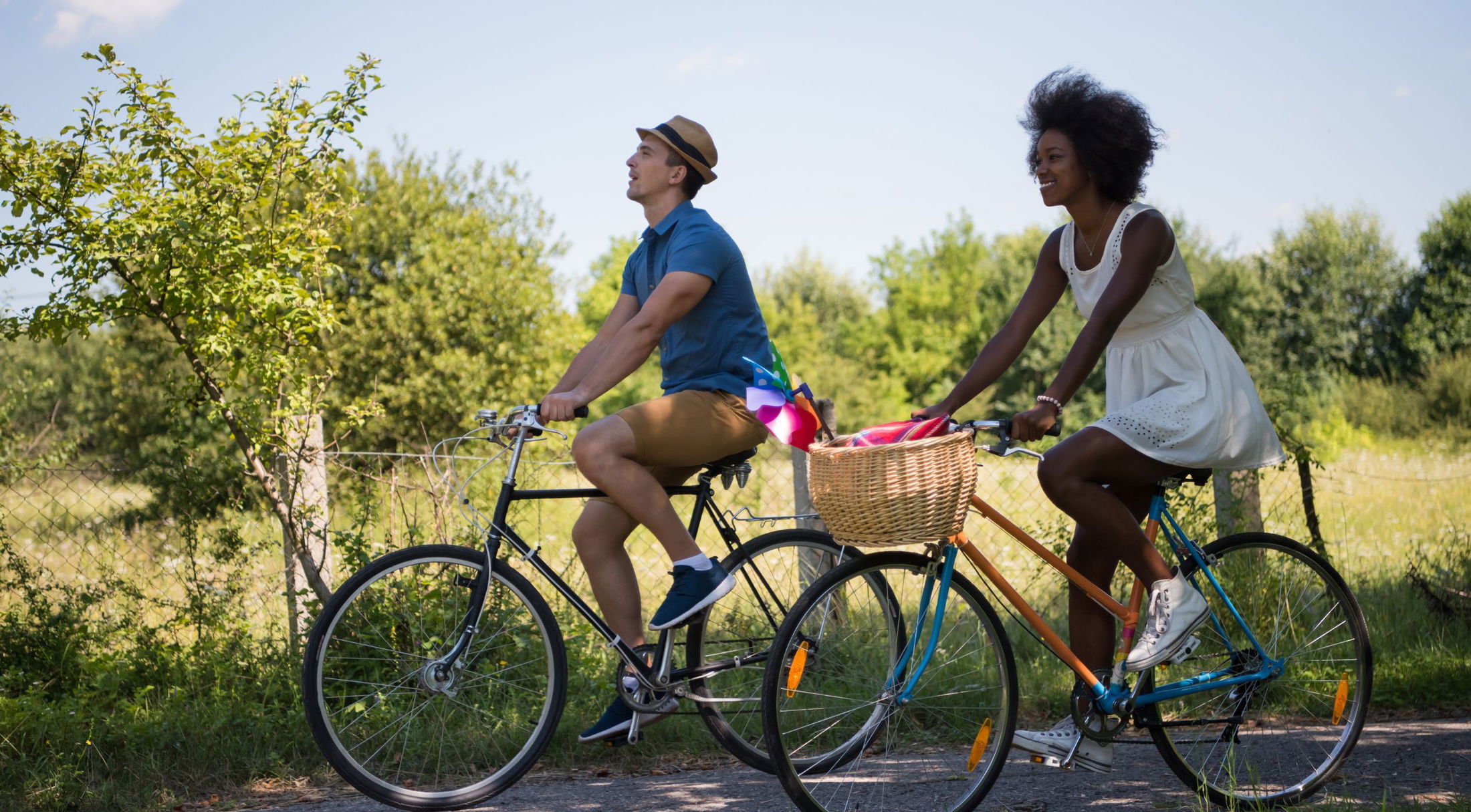a couple riding bikes along a trail in naples, fl