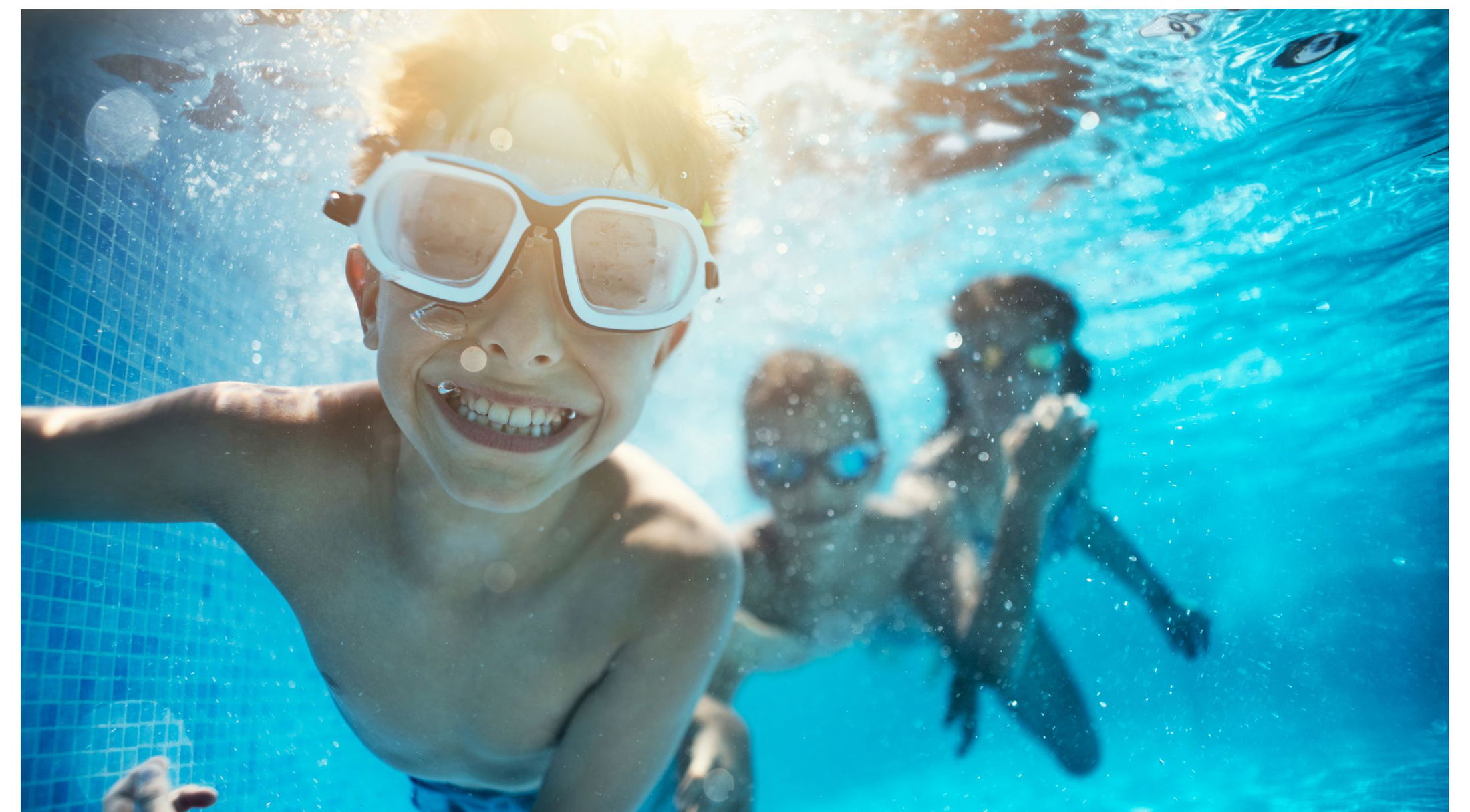 three children swimming under water in a pool in naples, fl