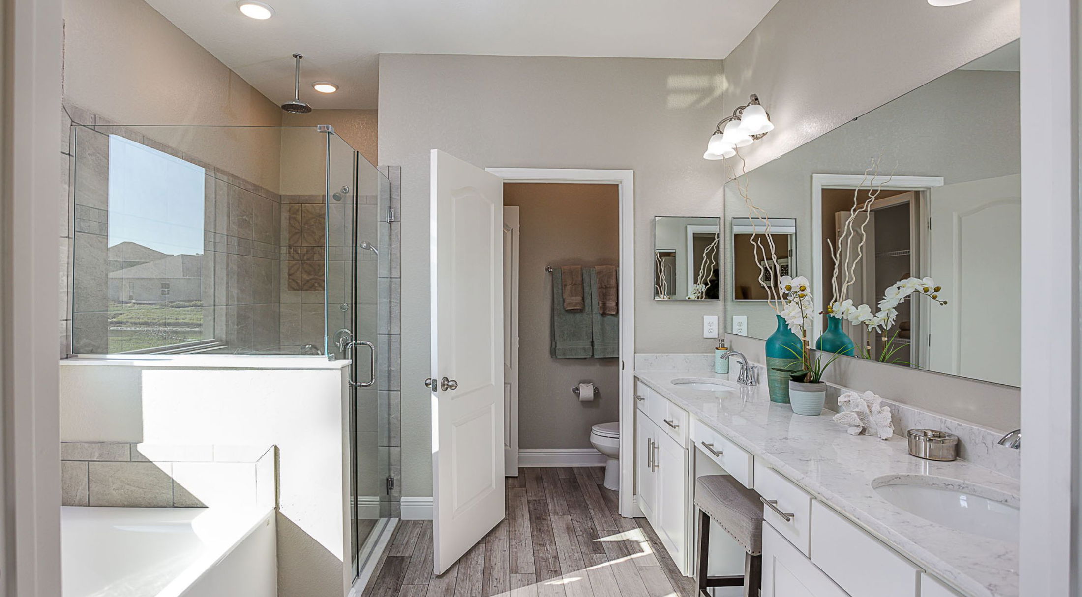 master bathroom of a new home in lakeland, fl with soaking tub and dual vanities