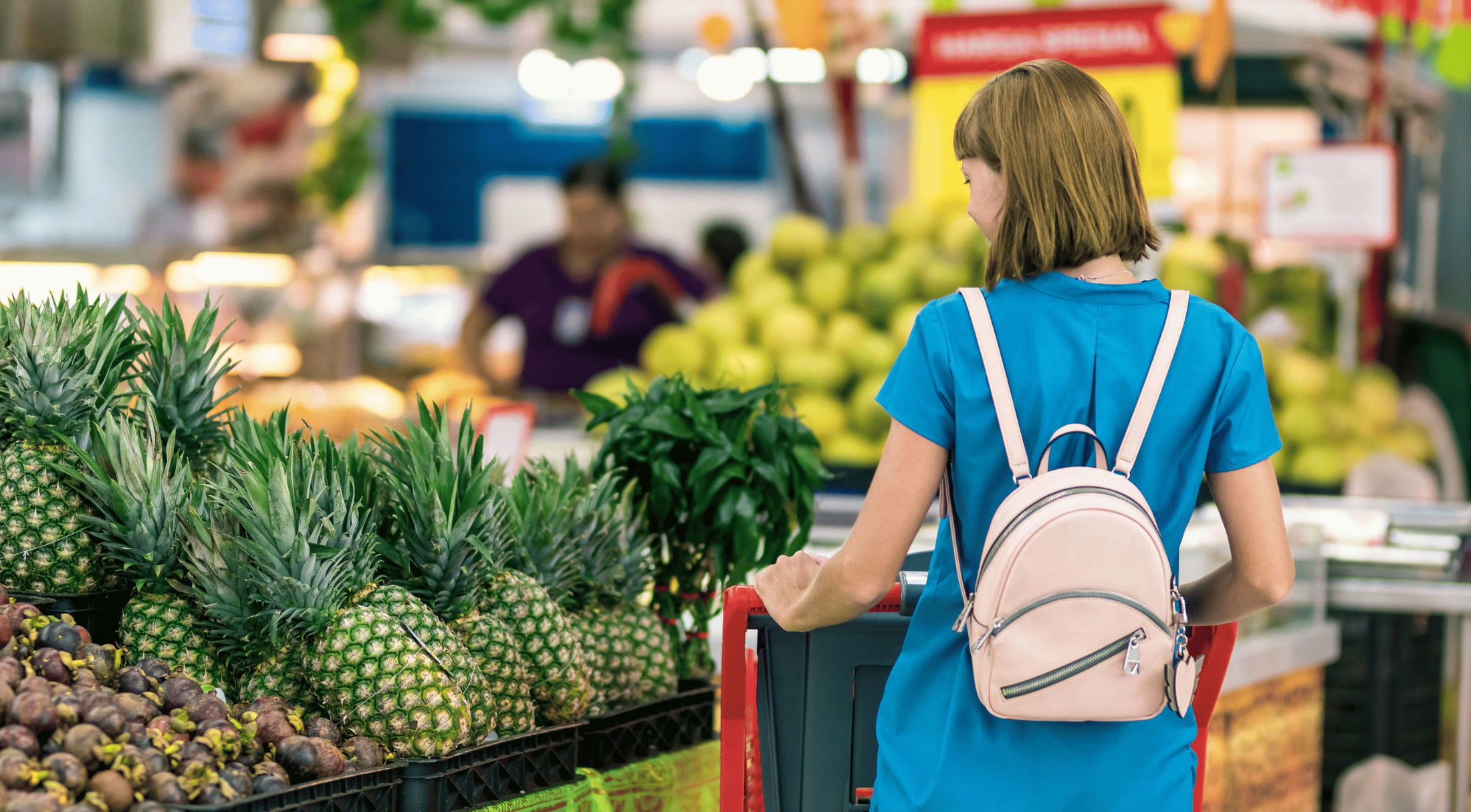 a woman shopping for produce in grocery store in lakeland, fl