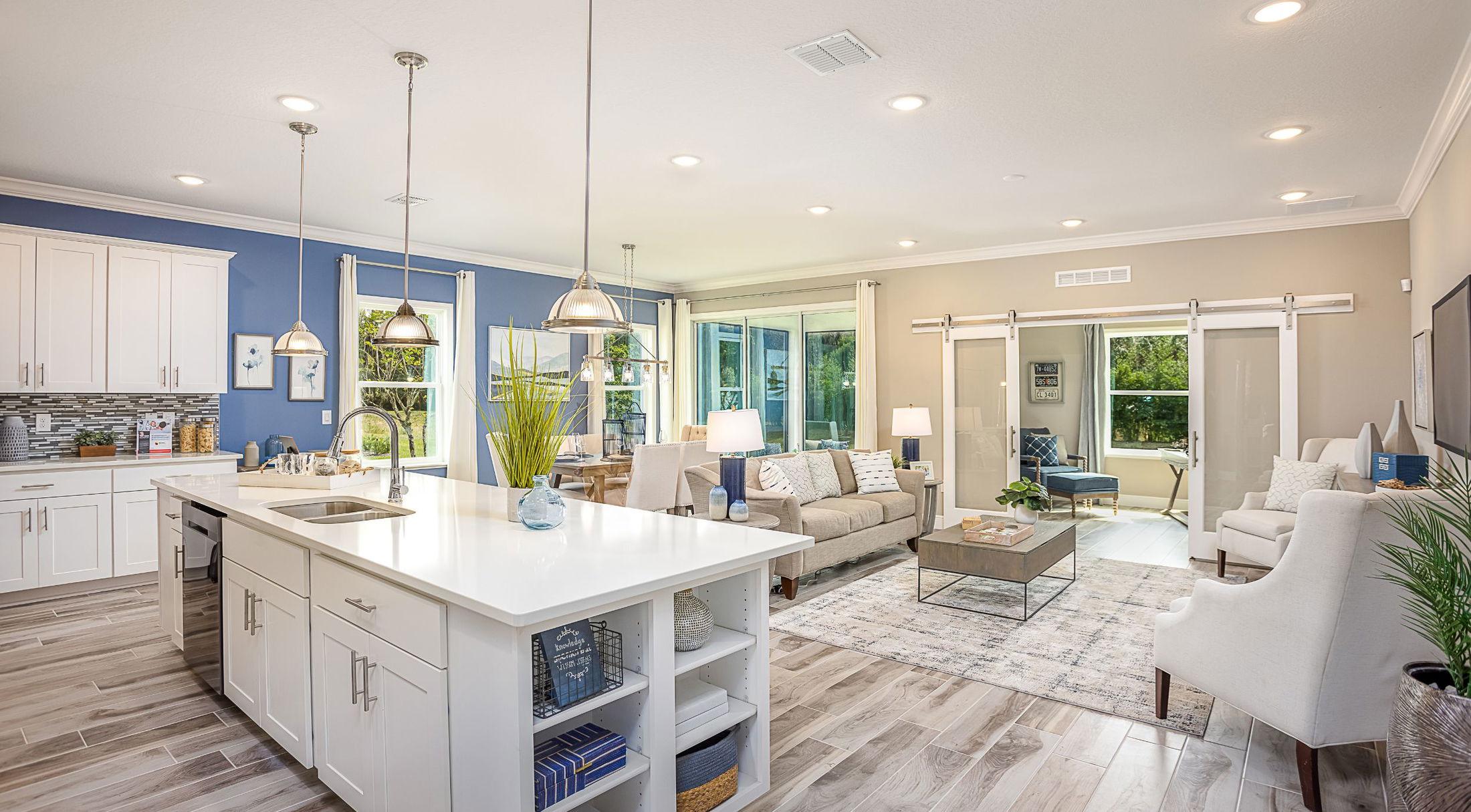open floor plan of a new home in lakeland, fl with white kitchen and neutral decor