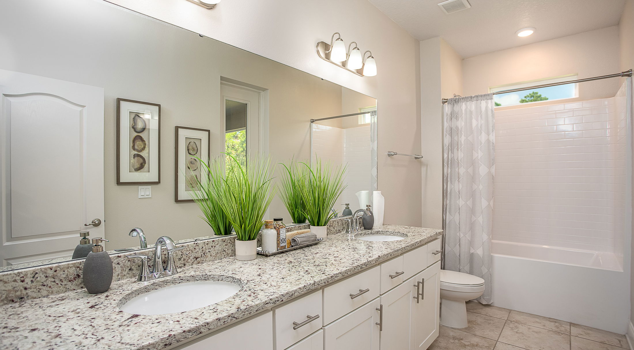 dual sink vanity and shower in a second full bathroom