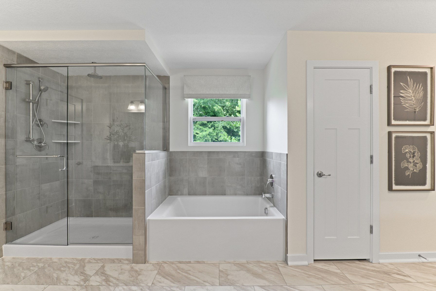 Modern bathroom featuring a glass-enclosed shower, large bathtub, and neutral decor with natural light.