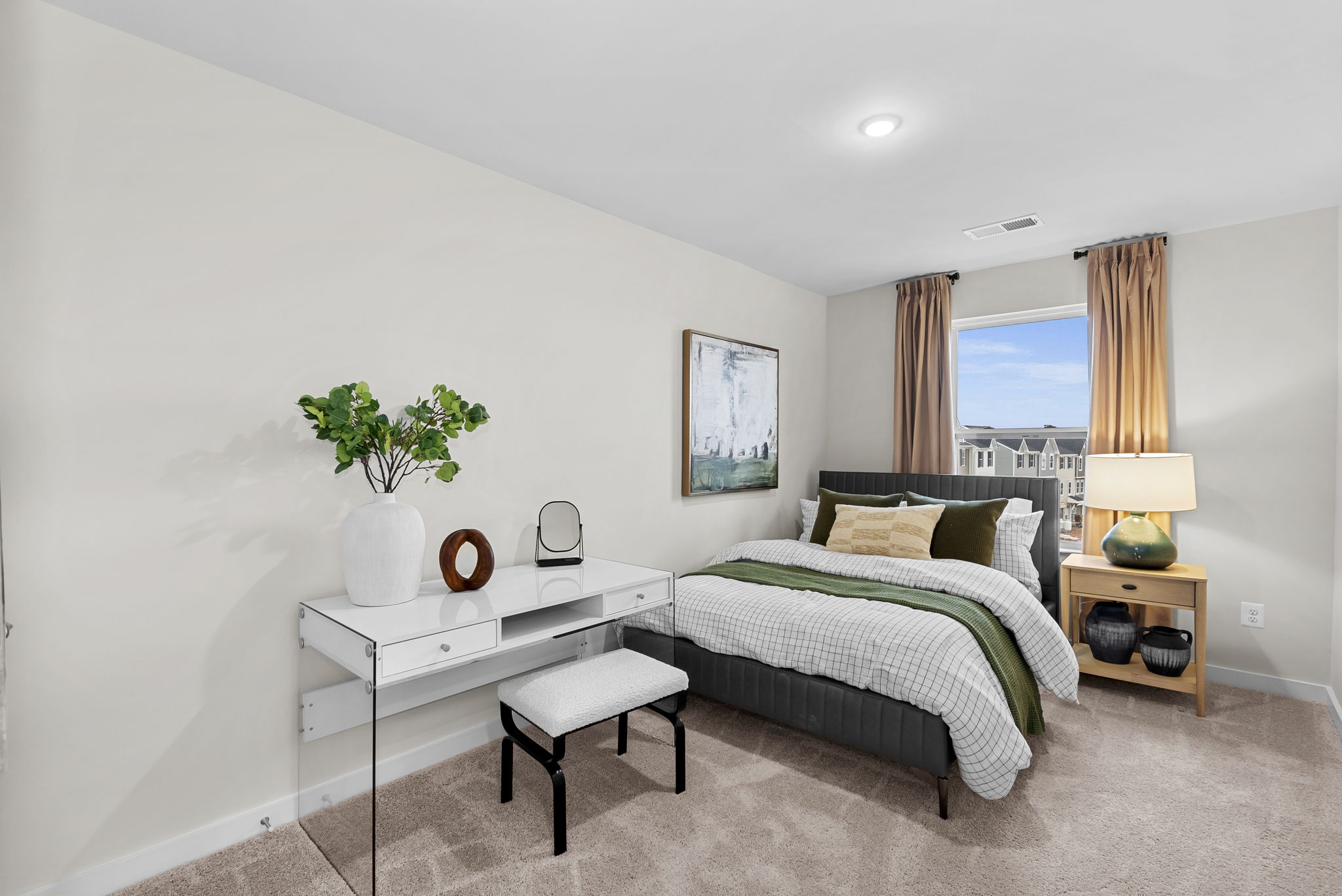 Modern bedroom with a cozy bed, stylish desk, and a window with beige curtains.