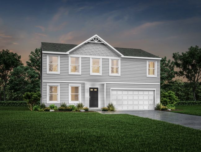 Two-story grey house with a gabled roof, white garage, and landscaped front yard at dusk.
