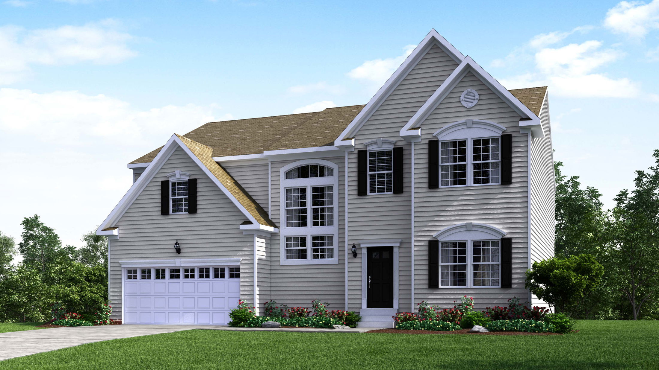 Two-story suburban home with gray siding, black shutters, and a neatly landscaped front yard under a clear blue sky.