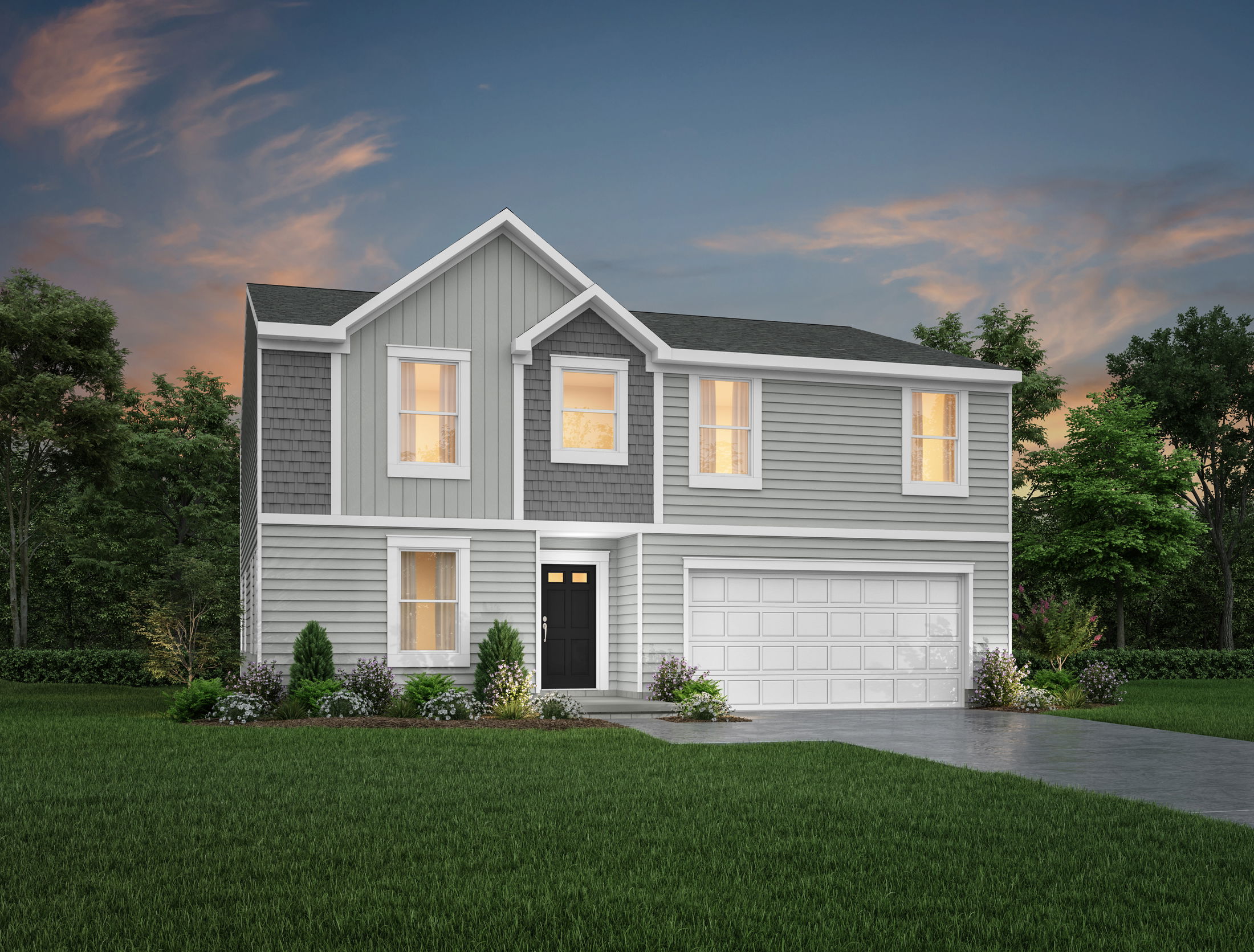 Two-story modern gray house with a black door, white garage, and well-maintained lawn at sunset.