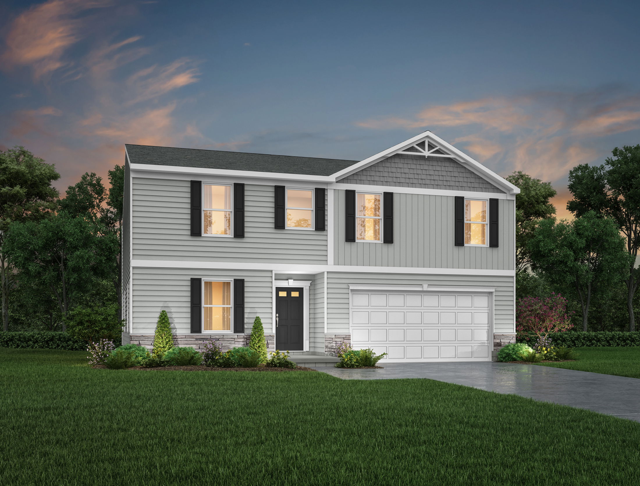 Two-story gray suburban home with white trim, illuminated windows, black shutters, and a manicured lawn at dusk.
