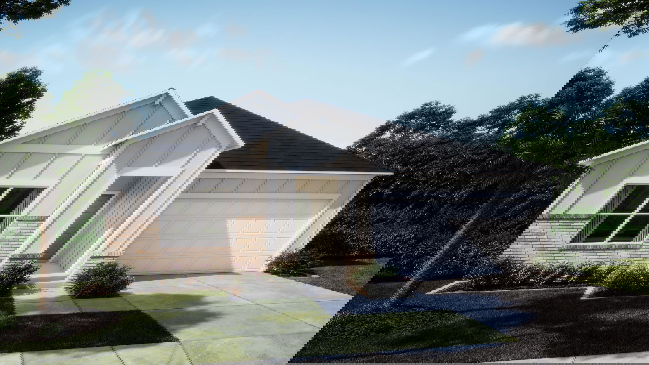 Modern suburban house with a two-car garage, landscaped front yard, and clear blue sky.