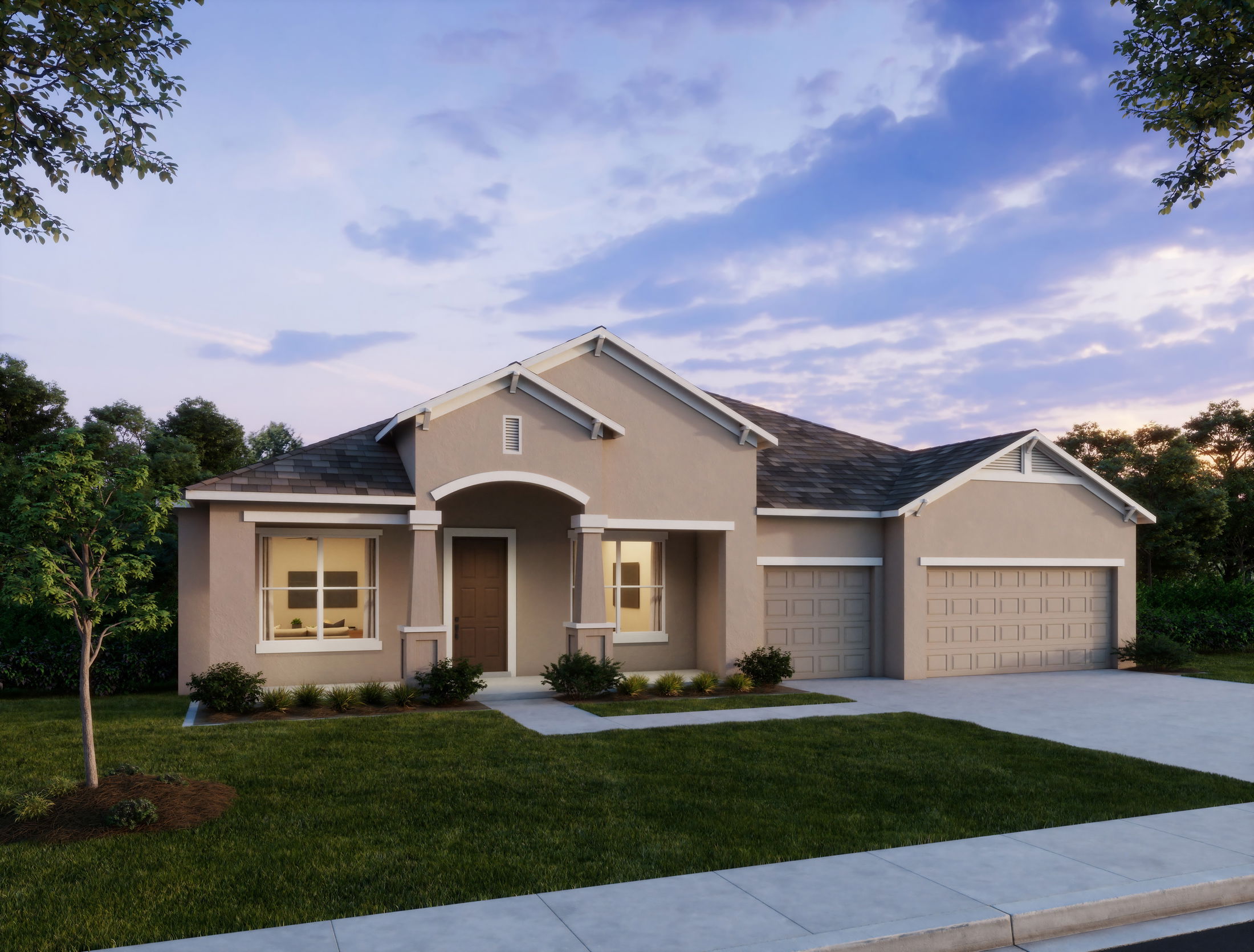 Modern single-story home with a two-car garage and lush landscaping at sunset.