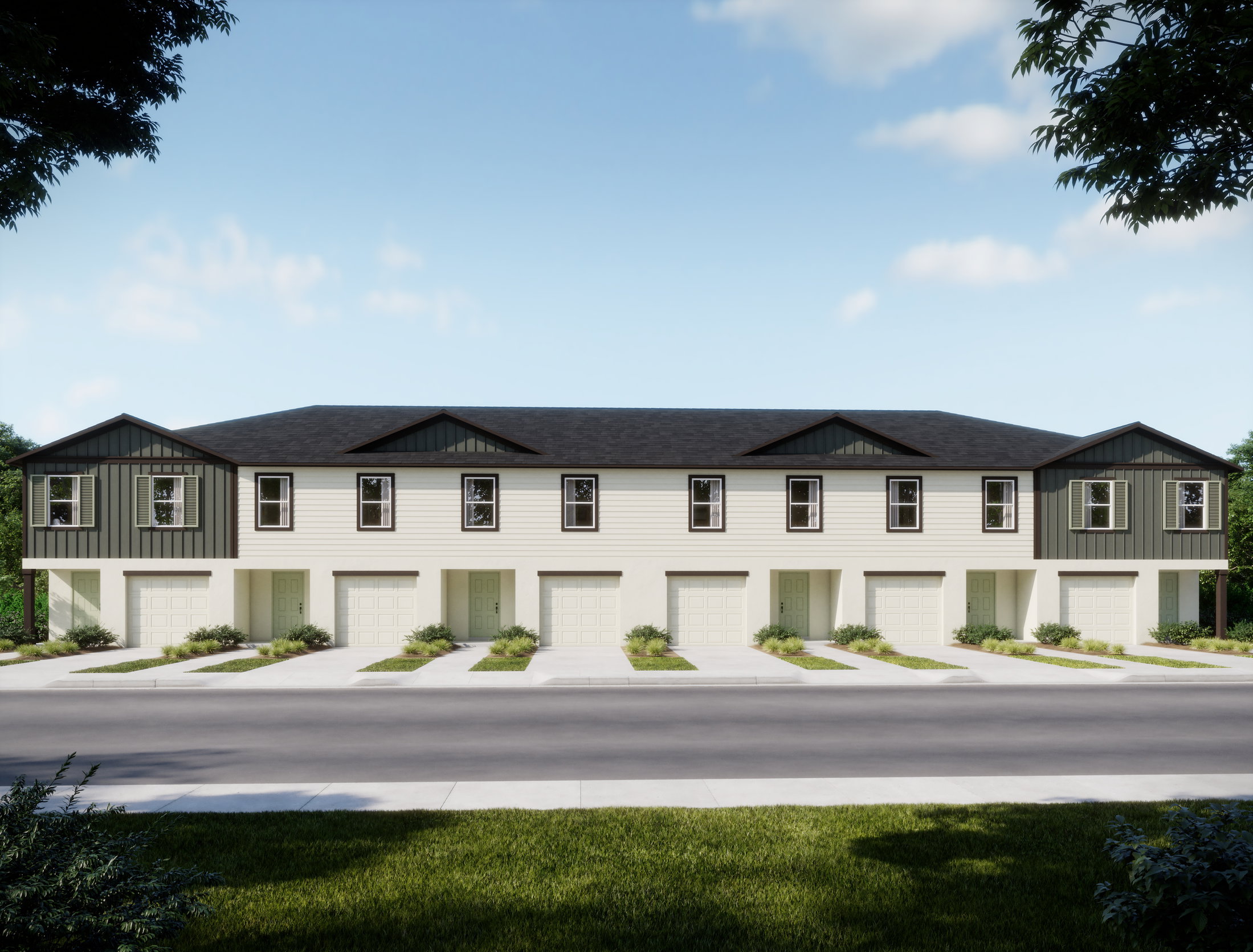 Newly constructed townhouses with a modern design and individual garages, lined along a paved street.