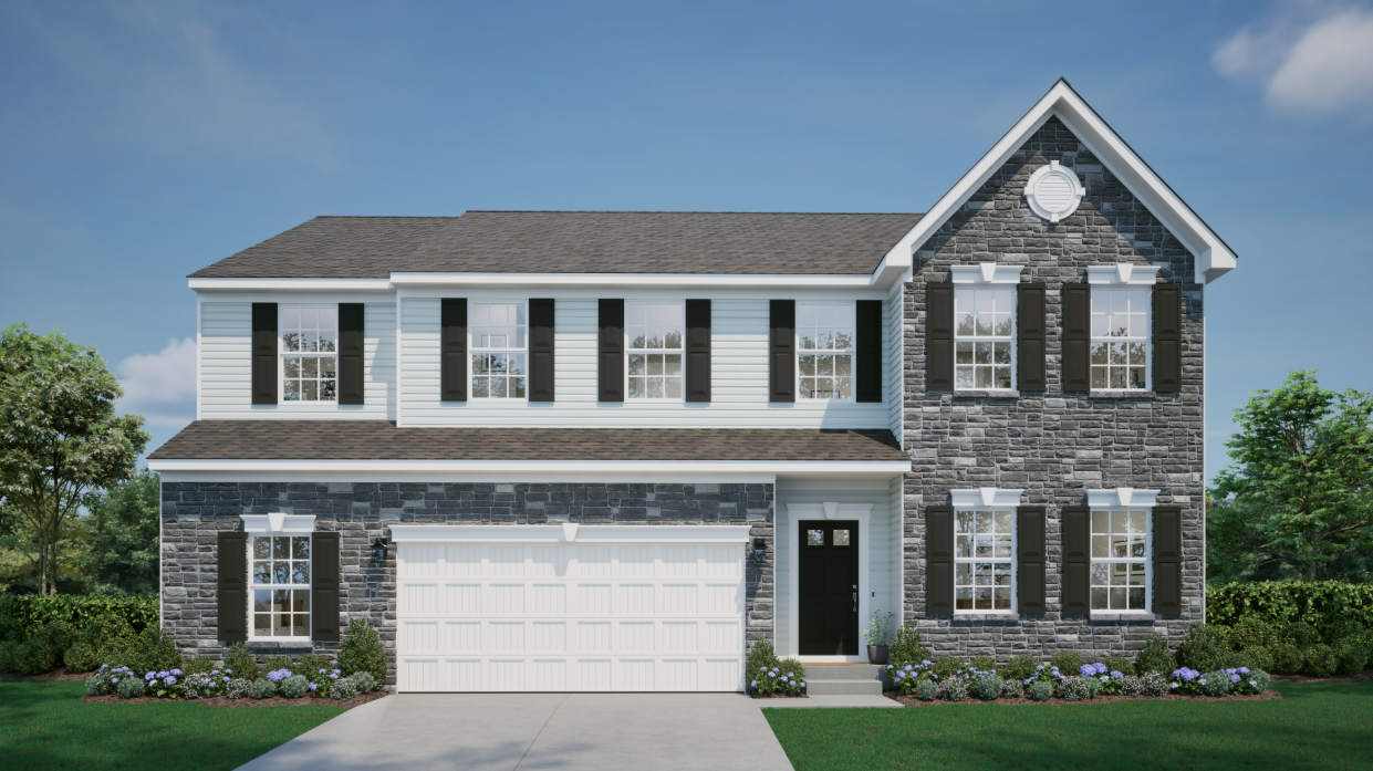 Modern two-story house with brick facade, black shutters, white garage door, and landscaped front yard.