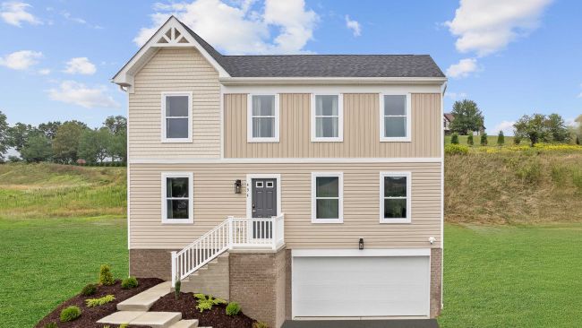 Two-story beige house with a gable roof, front porch, and attached garage set against a grassy landscape.