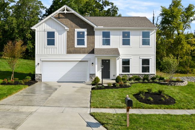 Two-story modern suburban house with a well-maintained lawn and double garage.