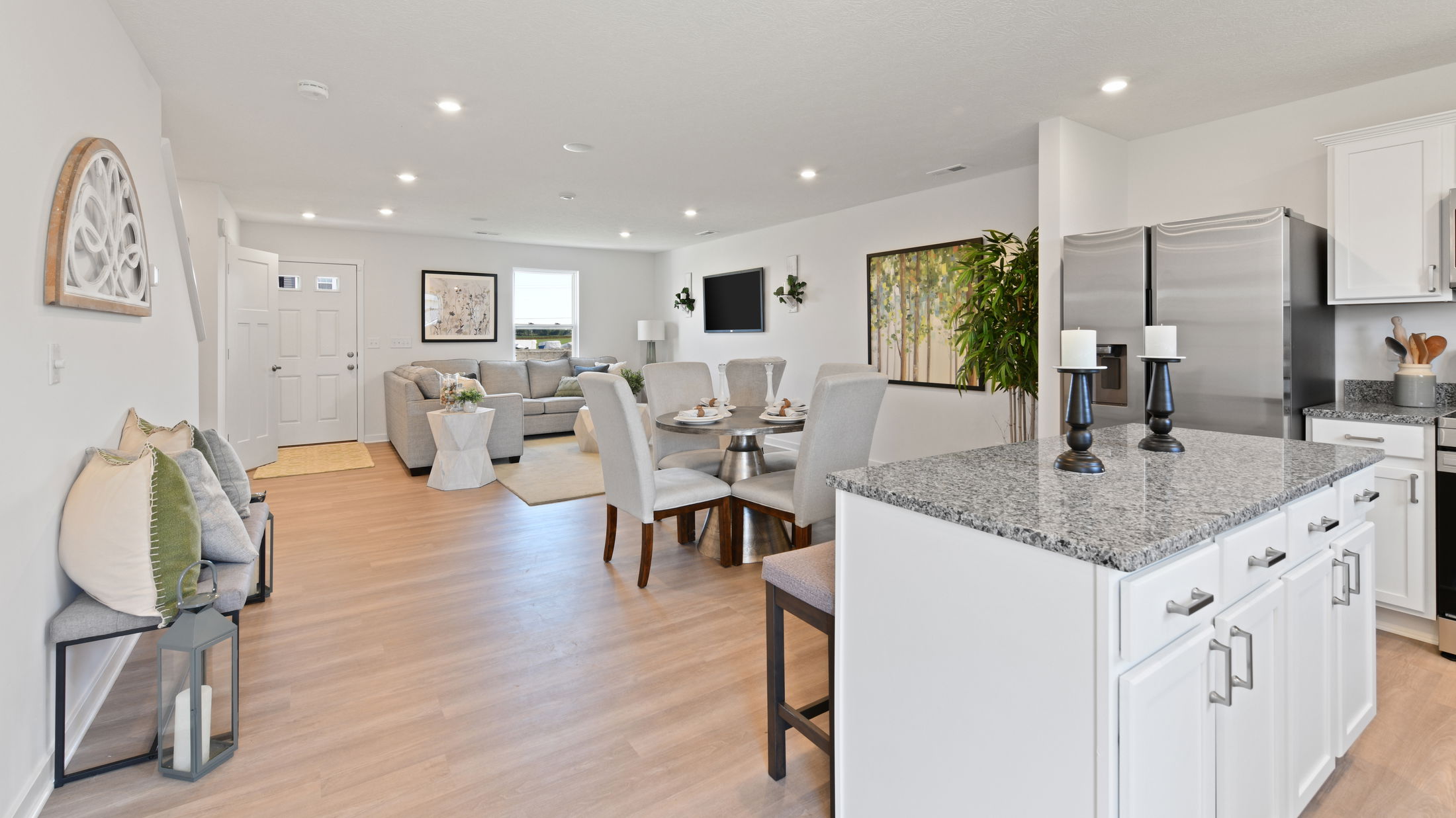 Modern open-concept living and dining area with contemporary furnishings and a stylish kitchen island.