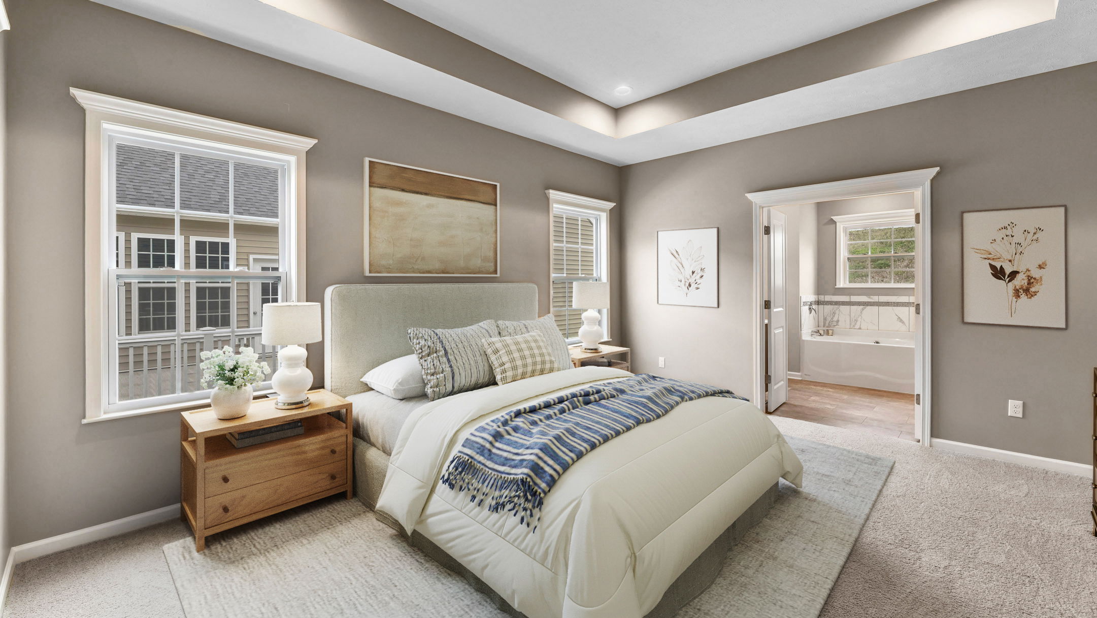 Luxurious master bedroom with a cozy beige bed, modern decor, and en-suite bathroom.