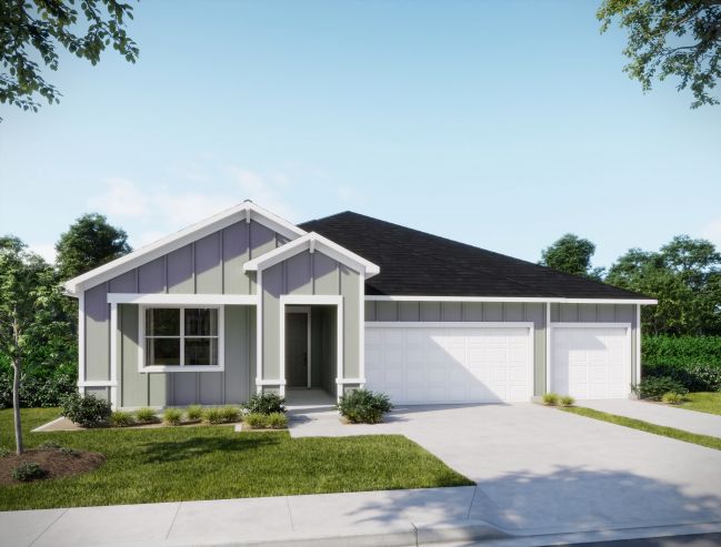 Modern single-story house exterior with a two-car garage, featuring a combination of light and dark siding surrounded by lush greenery.