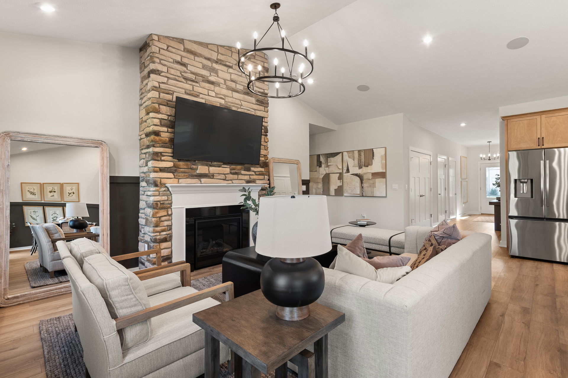 Modern living room featuring a stone fireplace, stylish furnishings, and contemporary decor.