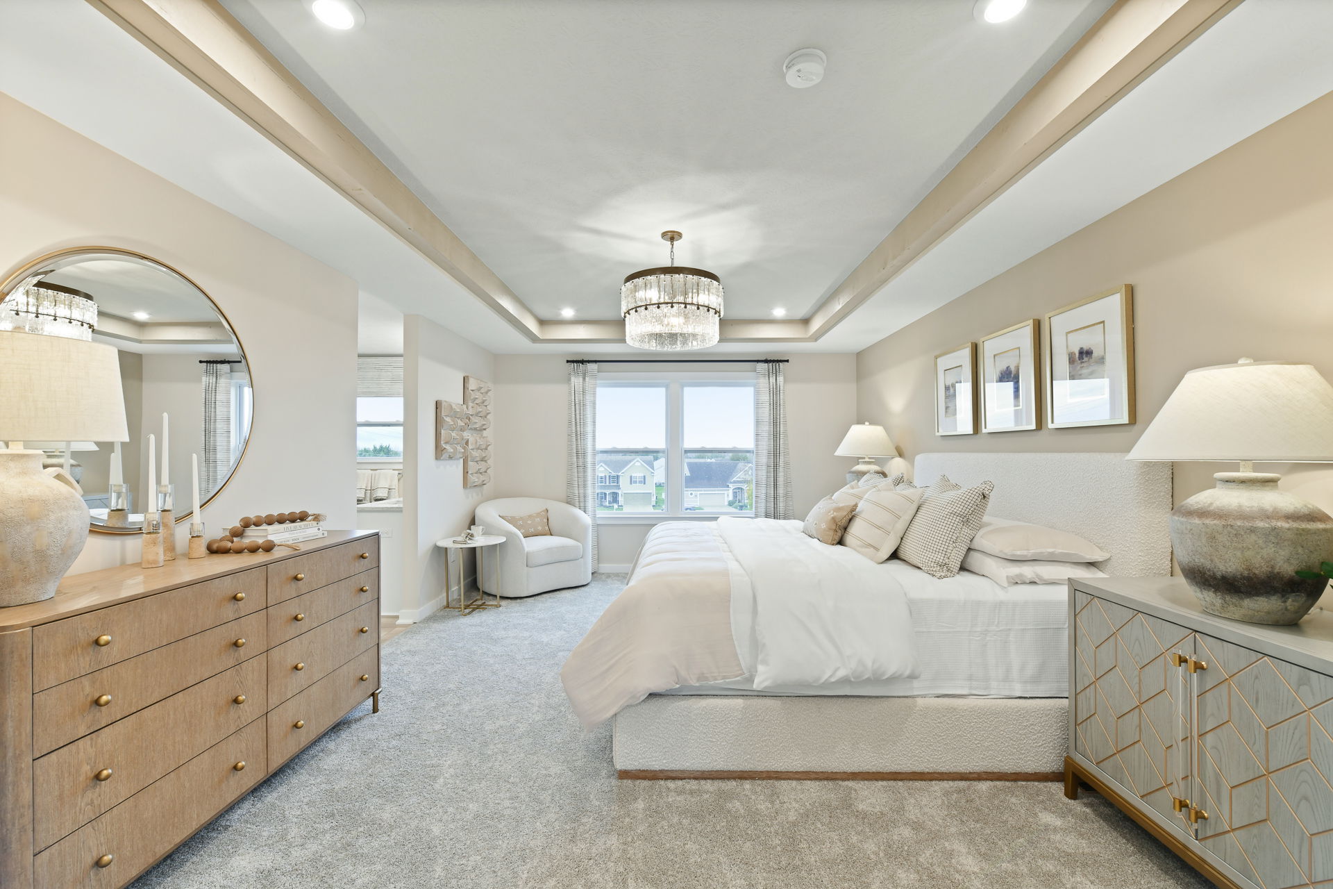 Elegant modern bedroom with stylish neutral decor, featuring a large bed, wooden dresser, and ambient lighting.