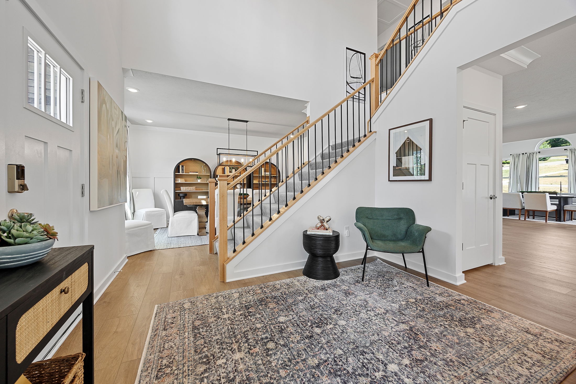 Modern home interior with wooden staircase, cozy seating area, and contemporary decor.