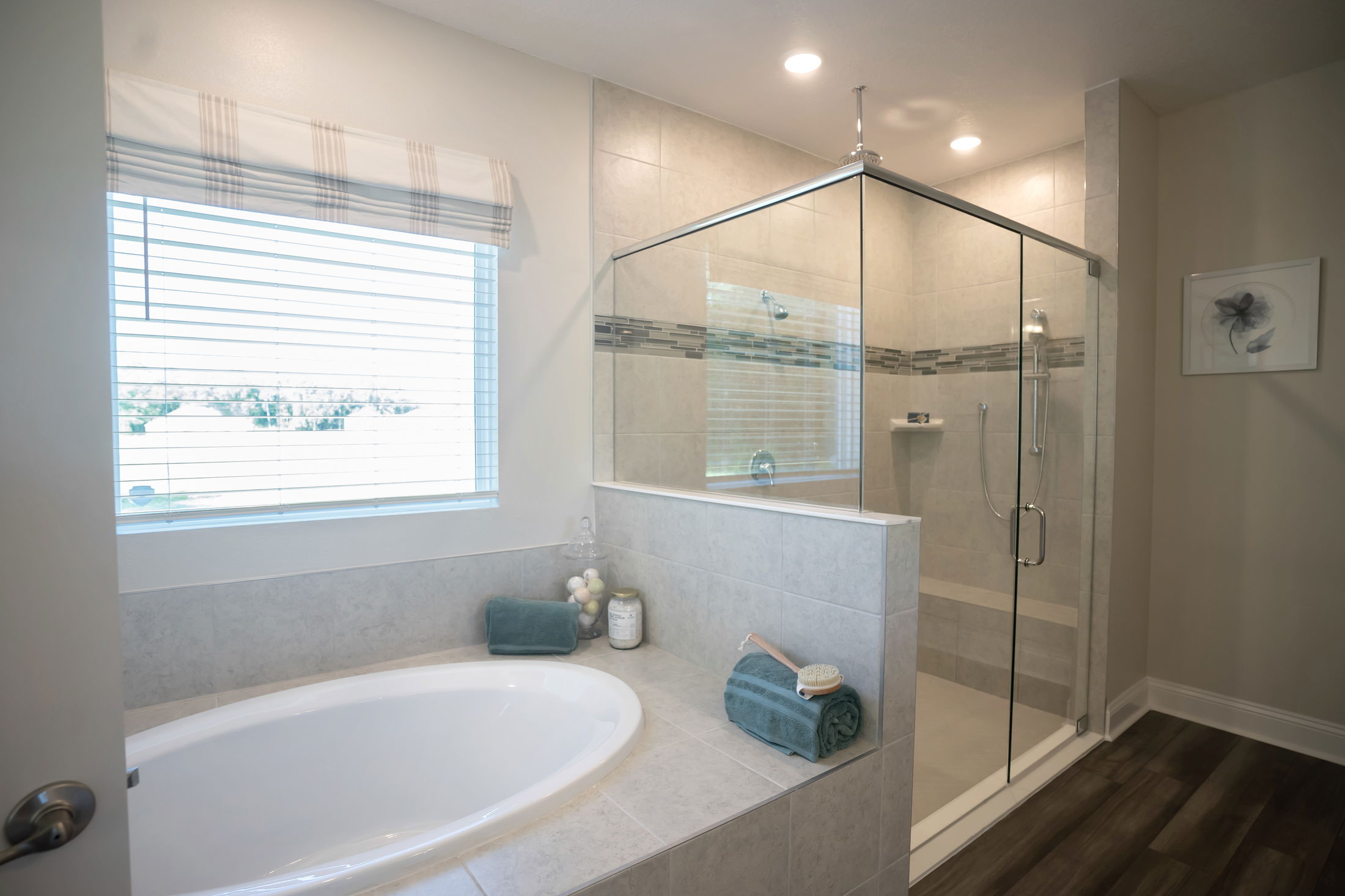 Modern bathroom with a glass-enclosed shower, a spacious bathtub, and elegant tile design.