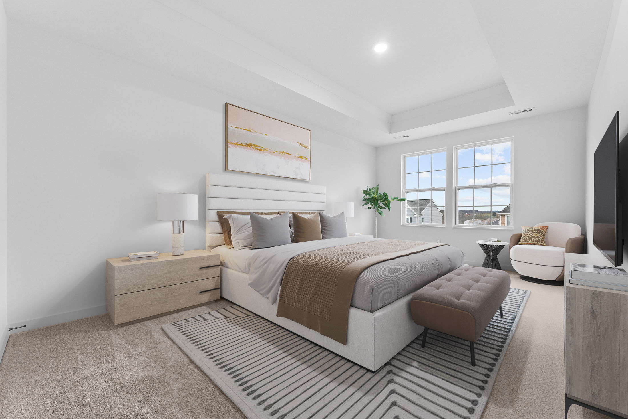 A modern, spacious bedroom with a beige and gray color scheme, featuring a large bed, wooden nightstands, a striped rug, and a window with outdoor views.