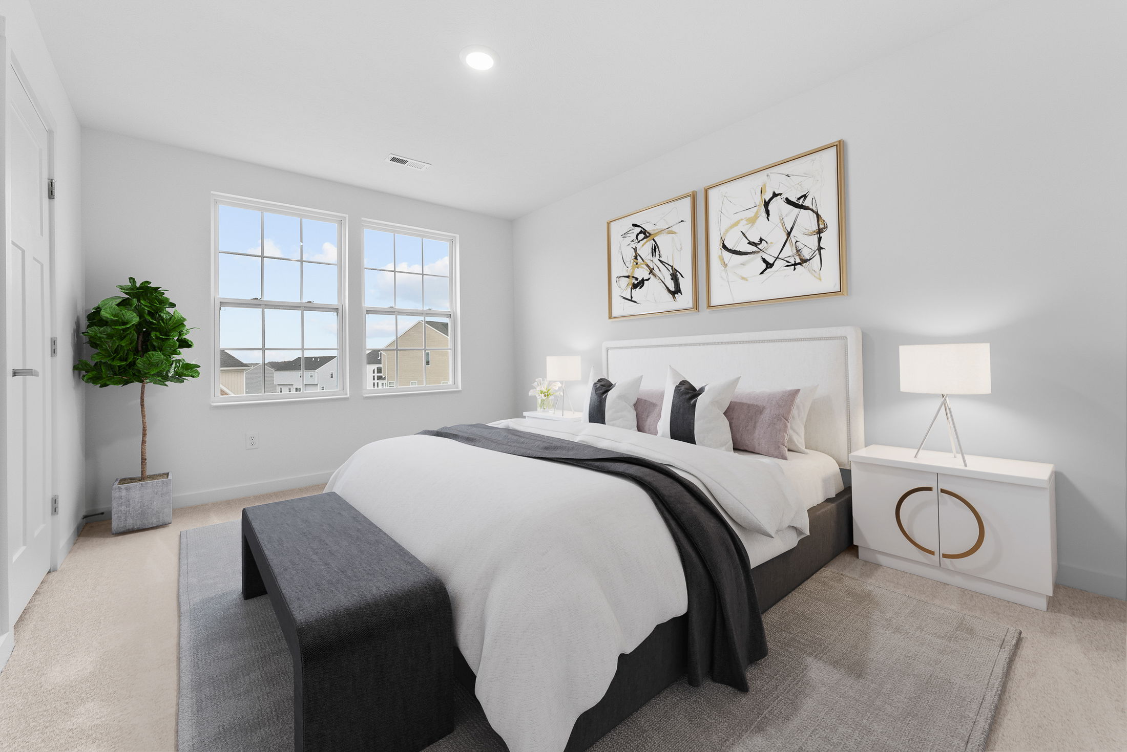 Modern, sunlit bedroom with a plush bed, abstract wall art, and minimalistic decor for a serene atmosphere.