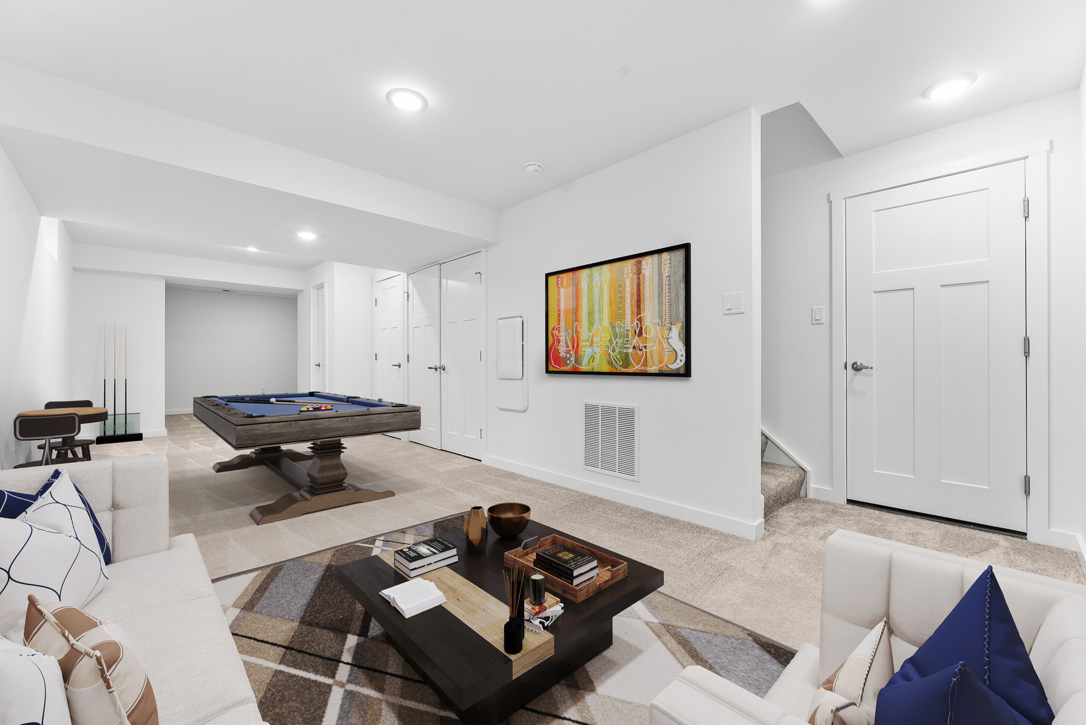 Modern basement game room with a pool table, stylish furniture, and colorful wall art.