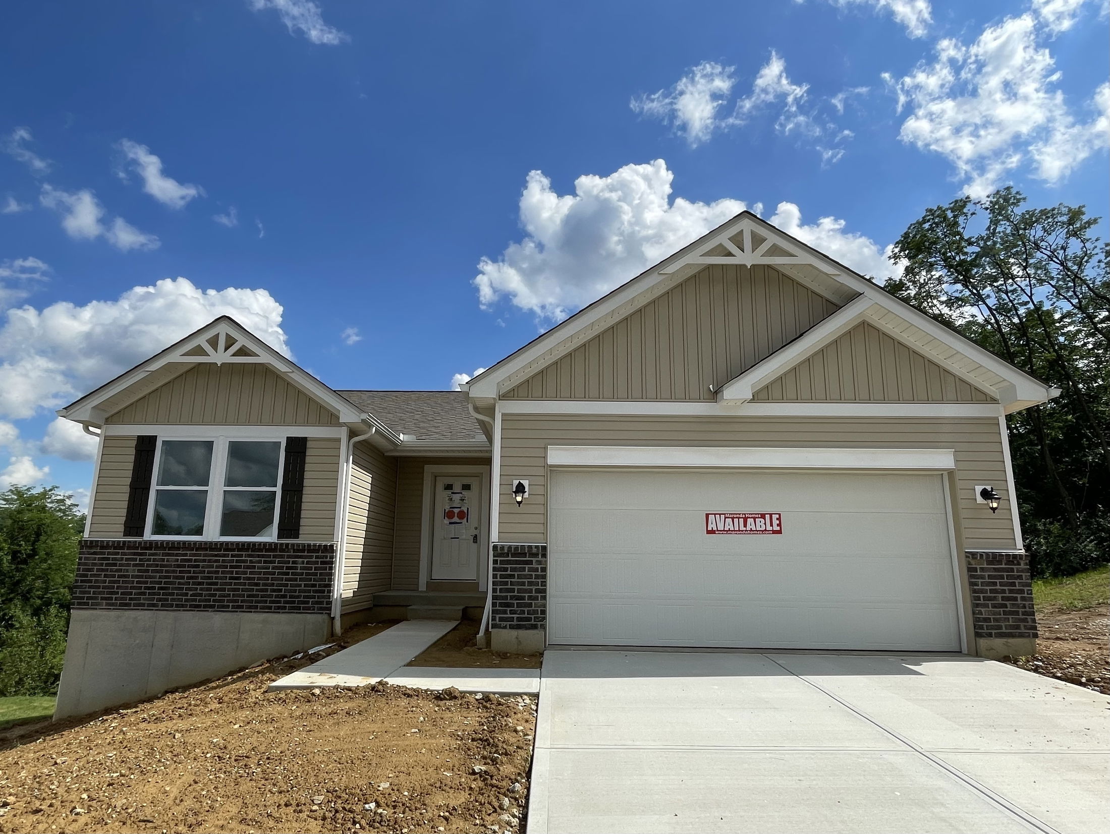 Newly built single-story home with a brick facade, two-car garage, and 
