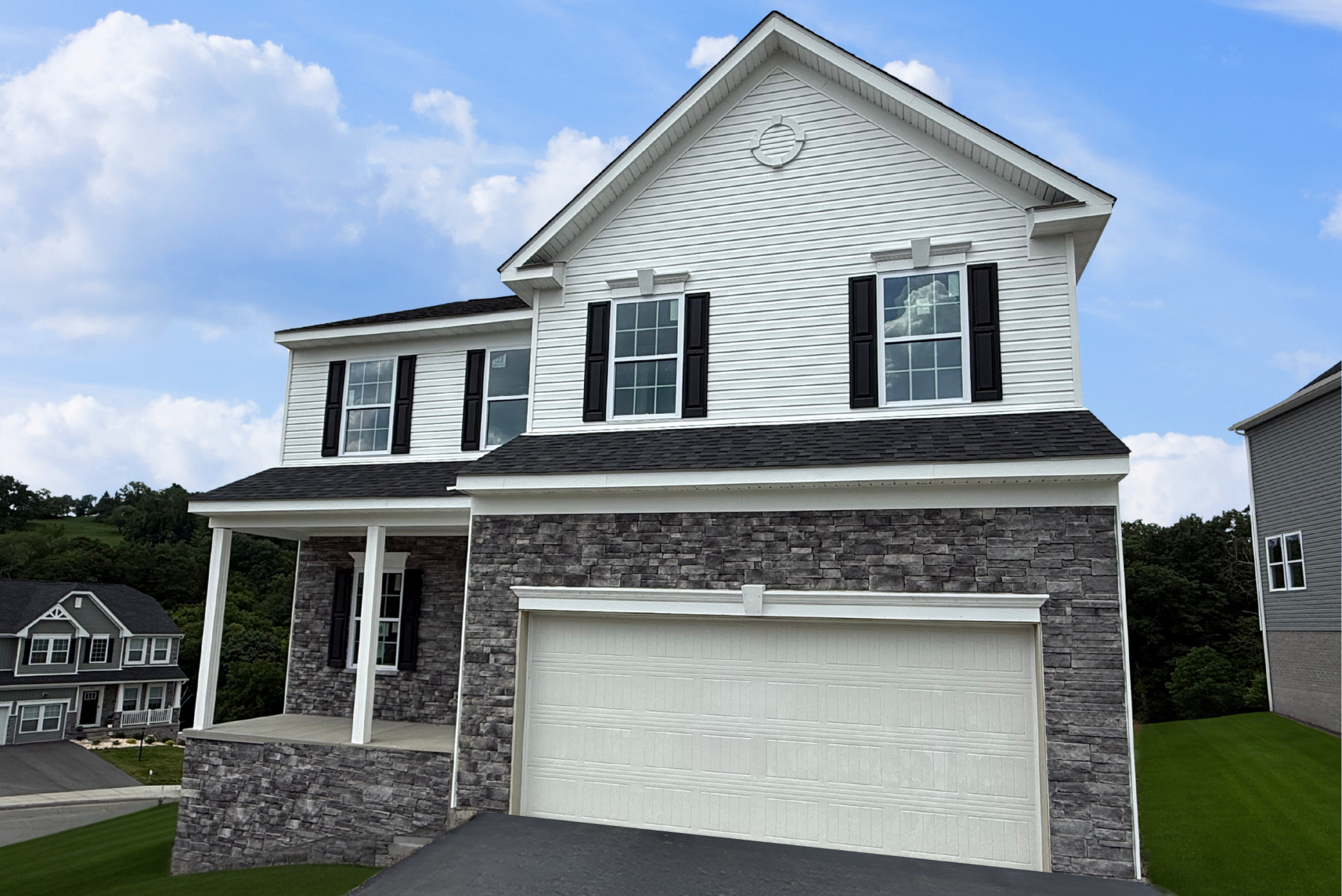 Modern two-story house with white siding, black shutters, and stone facade under a blue sky.